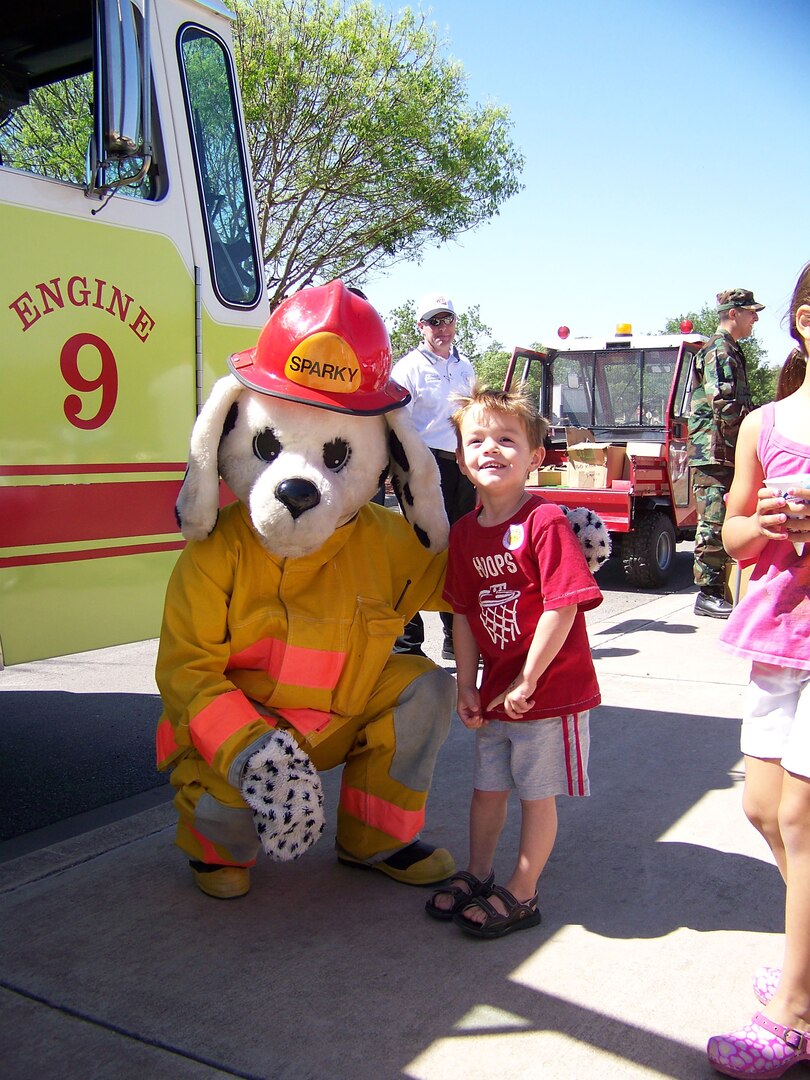 Trey Coalson says hello to Sparky, the base fire department mascot. (Photo by Maggie Armstrong)