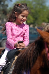 Danielle Hitchens enjoys a pony ride Saturday at the Fam-a-Ganza event at the youth center.(U.S. Air Force photo by Steve White)