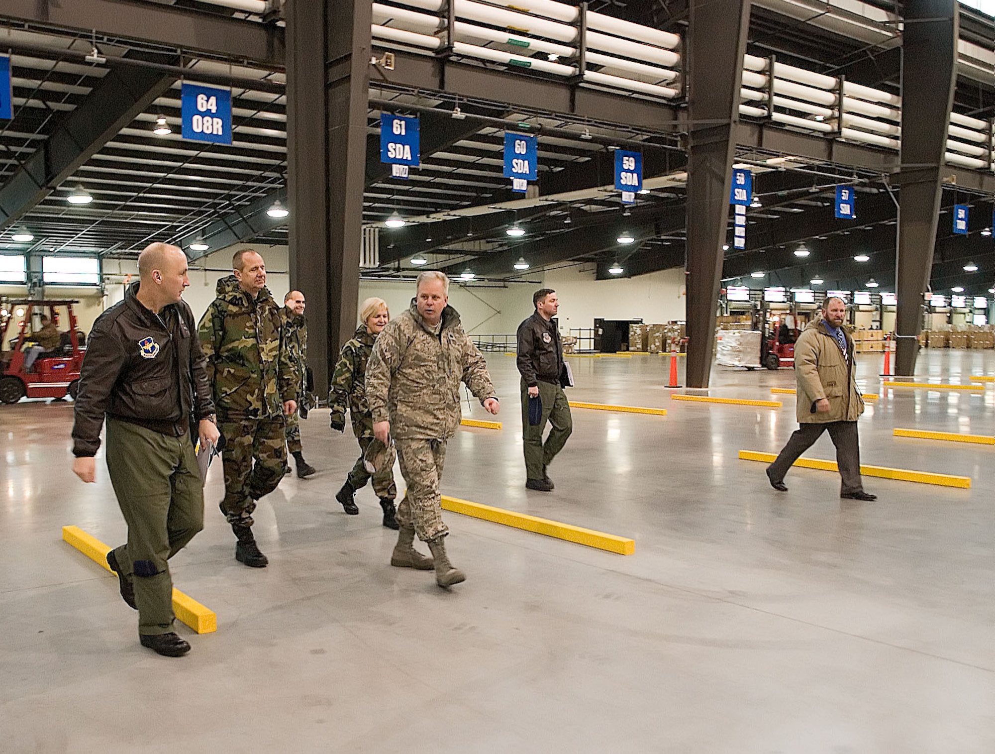 From left: Col. David Allvin, 97th Air Mobility Wing commander, Altus Air Force Base, Okla., Col. Dave Wuest, 512th Airlift Wing vice commander, Maj. Michael Riley, 436th Aerial Port Squadron, Col. Elaine Barron, 512th Mission Support Group commander, Lt Col. Brian Fletcher, 436th APS commander , Lt Col. Tom Loper, 436th Operations Support Squadron, and Jim Ewing, 436th Aerial Port Squadron, listen to Colonel Fletcher describe Dover’s brand-new Super Port during the Installation Excellence Selection Board visit. (U.S. Air Force Photo/Jason Minto)