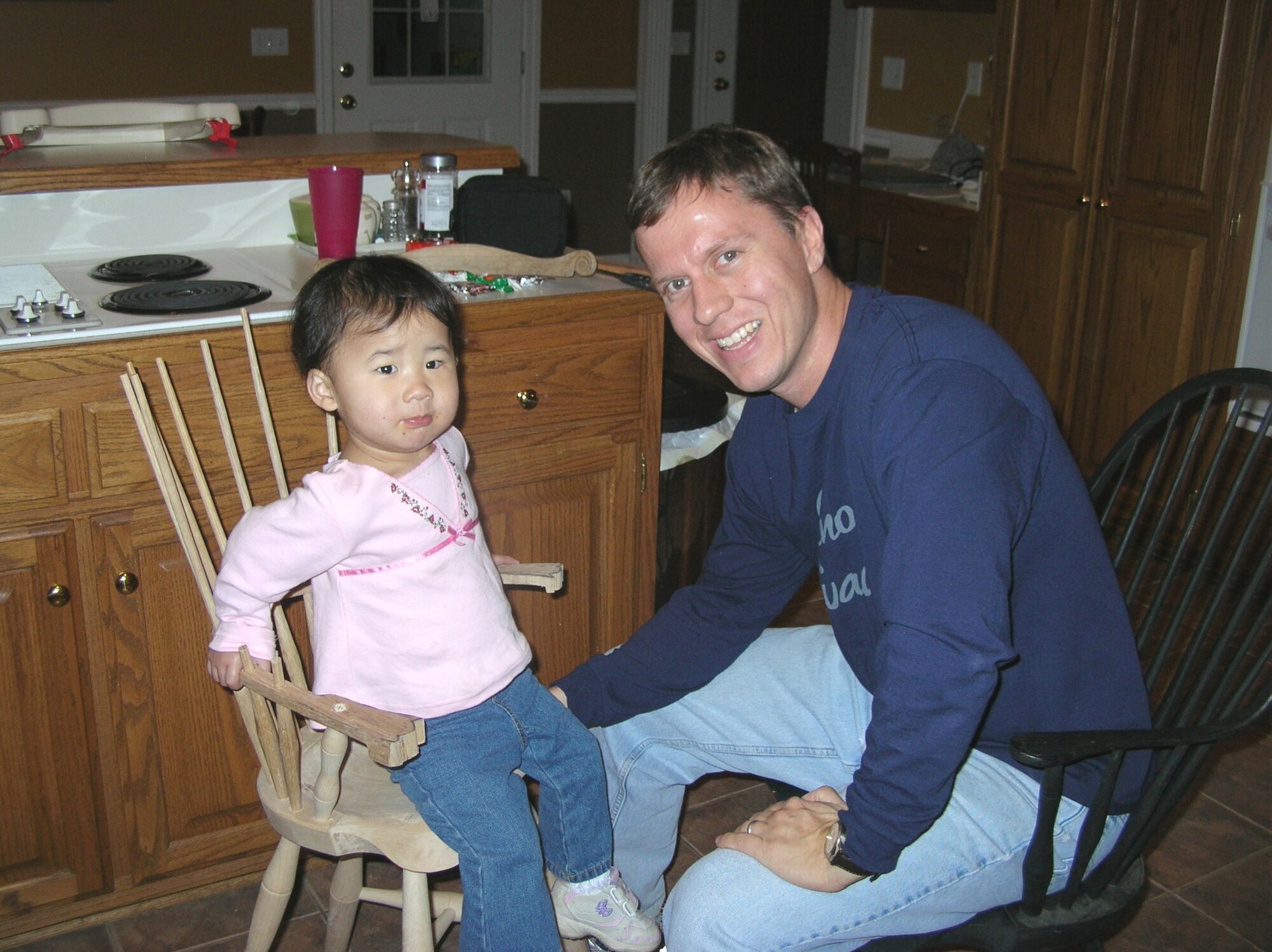 Megan tries out the new high chair her father, Anthony Watts, was building. He is a senior engineer with Dynetics, Inc., at Arnold Engineering Development Center. (Photo provided)