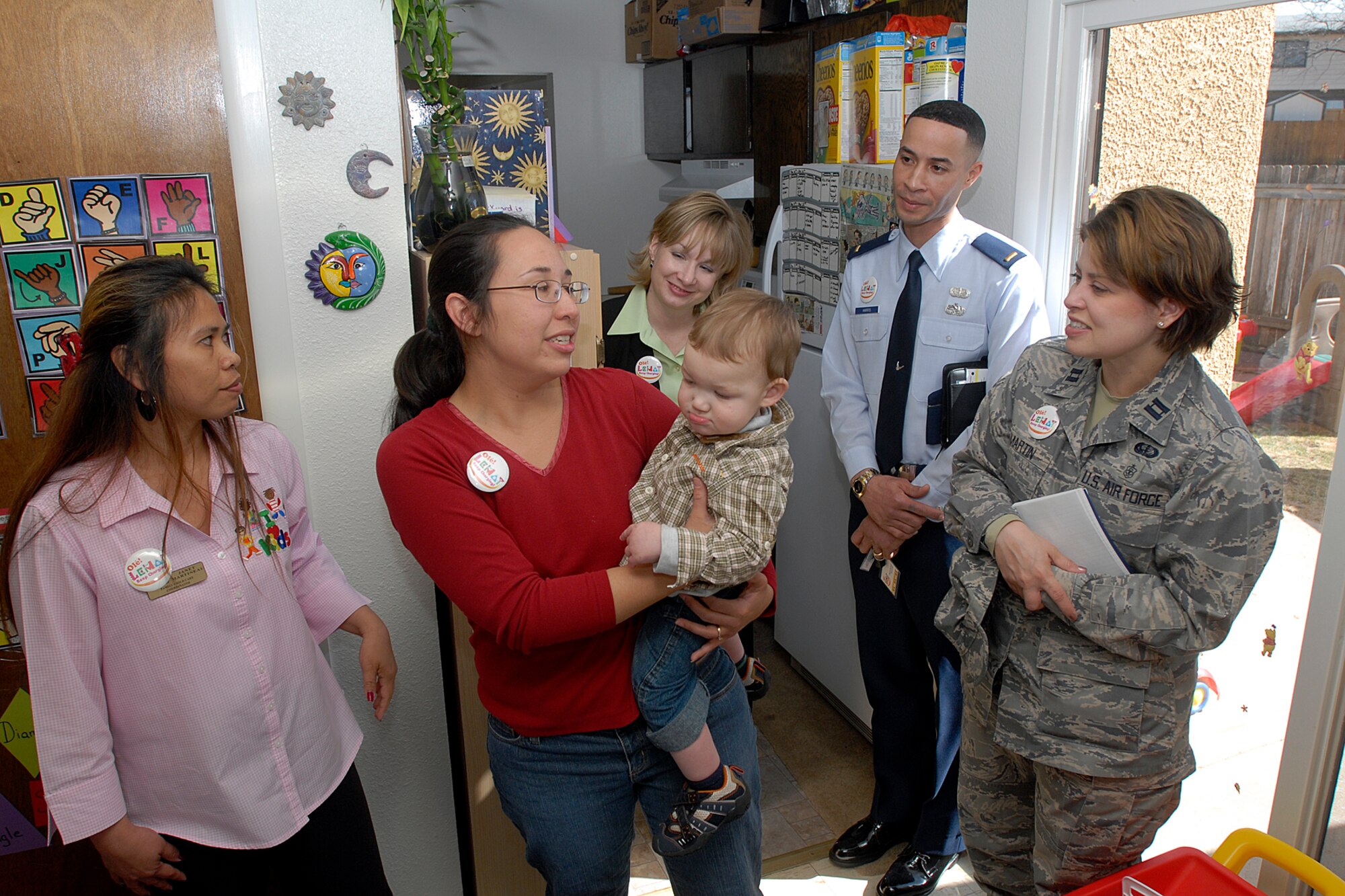 An in-home child care provider, together with Janet Martineau, the Family Child Care director, gives the Air Force-level Gen. Curtis E. LeMay award inspection team a first-hand look at how Peterson Air Force Base certifies home child care providers April 8 in base housing. The team inspected the 21st Services Squadron April 7-11 at this Colorado base to see if they qualified as the “best of the best” of services squadrons throughout the Air Force. (U.S. Air Force photo/Larry Hulst)