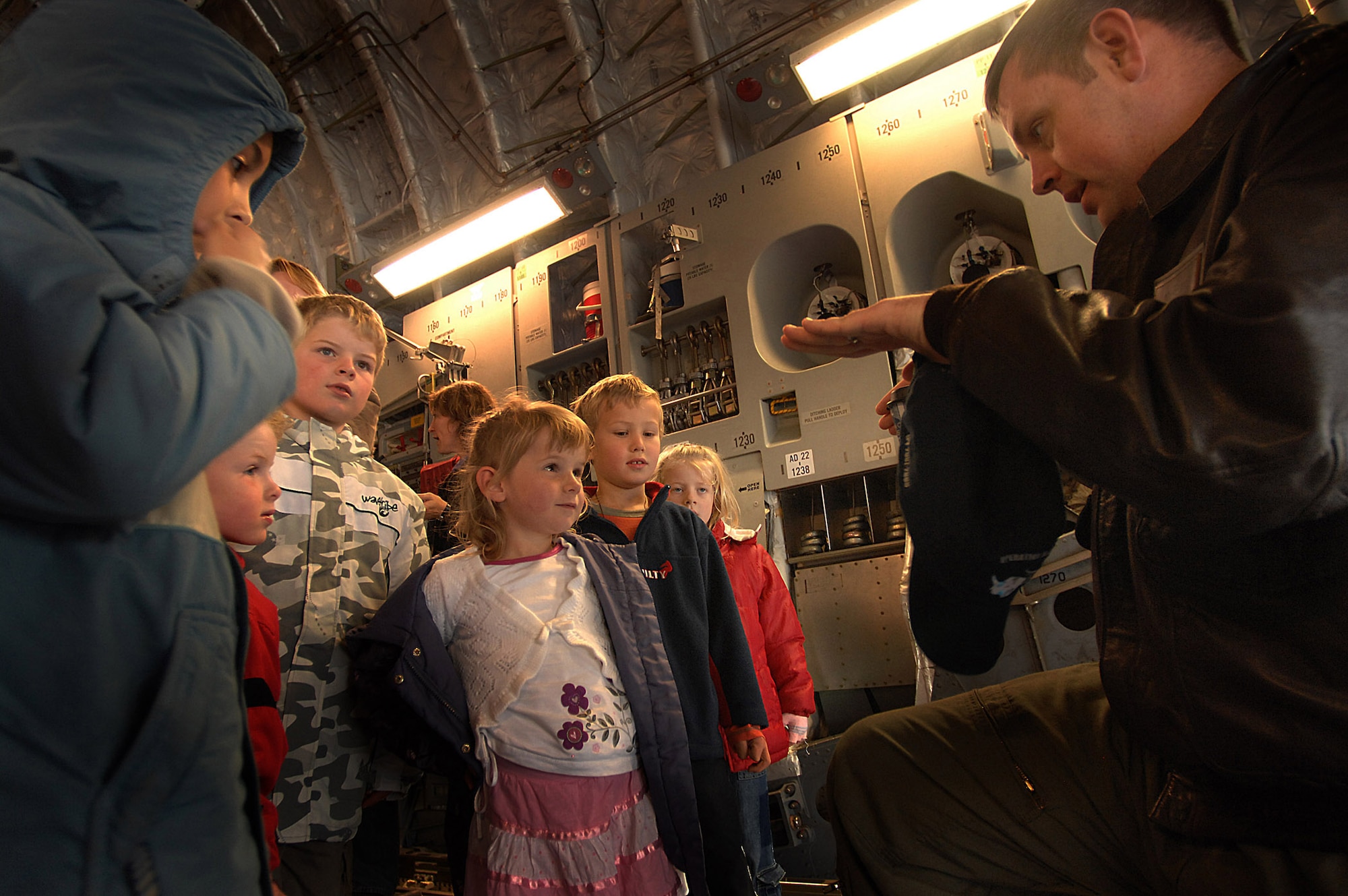 Capt. Corey Simmons, a pilot from the 62nd Airlift Wing, McChord Air Force Base, Wash., explains features of the C-17 Globemaster III to a group on New Zealand children.  The C-17, flown by a total force aircrew of Reserve and active-duty Airmen from the 446th and 62nd Airlift Wings at McChord, is staging out of Christchurch for Operation Deep freeze in Antarctica. (U.S. Air Force photo/Staff Sgt. Aaron Allmon)