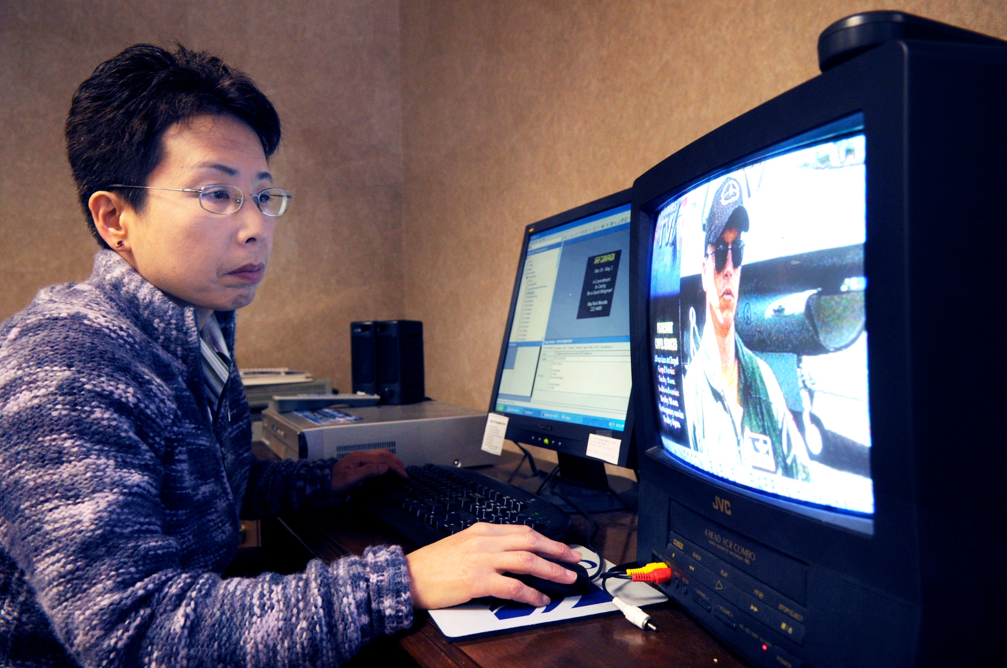 Misuzu Allen works on  program content for the commanders action channel. U. S. Air Force photo by Sue Sapp