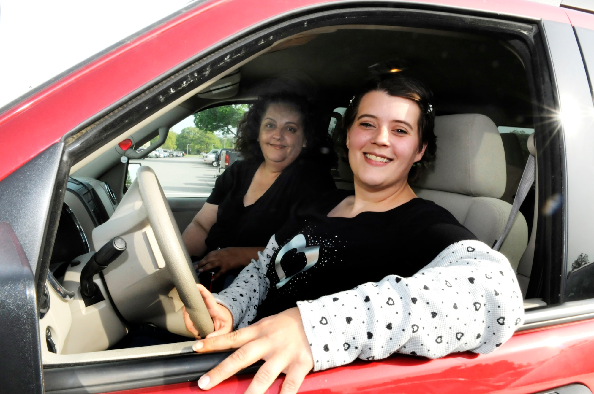 L-R Kristi Kennedy, and Stacie Fitzgerald regularly carpool to their jobs at Robins. Ms Fitzgerald received the spotlight award ($100 gift card) from the Clean Air Campaign for carpooling 128 times from Oct. 1 - Dec. 31. She plans to share the award with Ms Kennedy. U. S. Air Force photo by Sue Sapp
