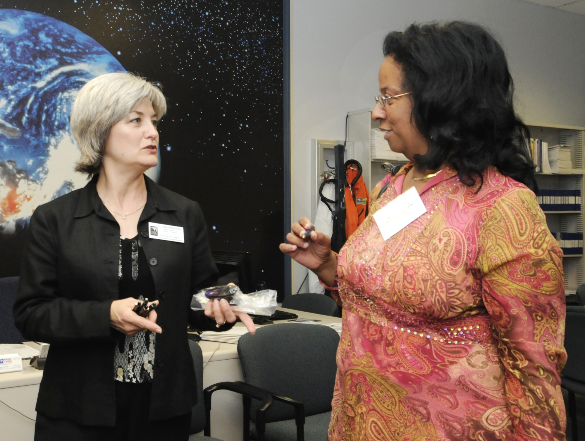 Clare Swinford, NASA Educator Resource Center coordinator, talks with Rosemary Knight, Georgia Academy for the Blind school social worker about the educational resources the museum offers for youth. U. S. Air Force photo by Sue Sapp