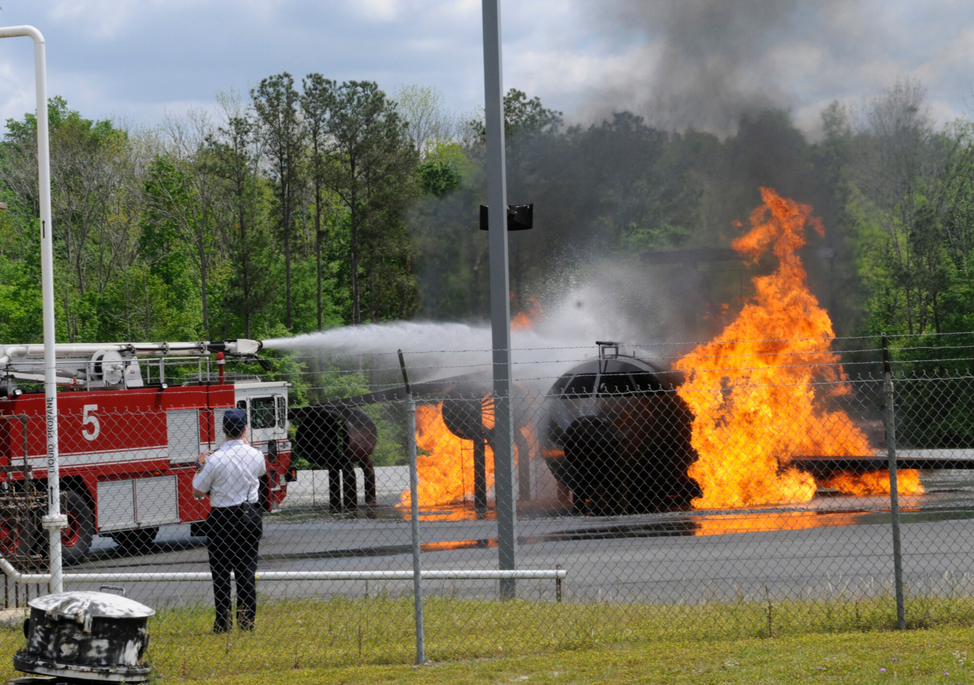 Robins firefighters extinguish a flaming C-130 as part of an Operational Readiness Inspection Emergency Management exercise. Robins Exercise Evaluation Team was being evaluated by Air Force Materiel Command Inspector Generals during this exercise. U. S. Air Force photo by Sue Sapp
