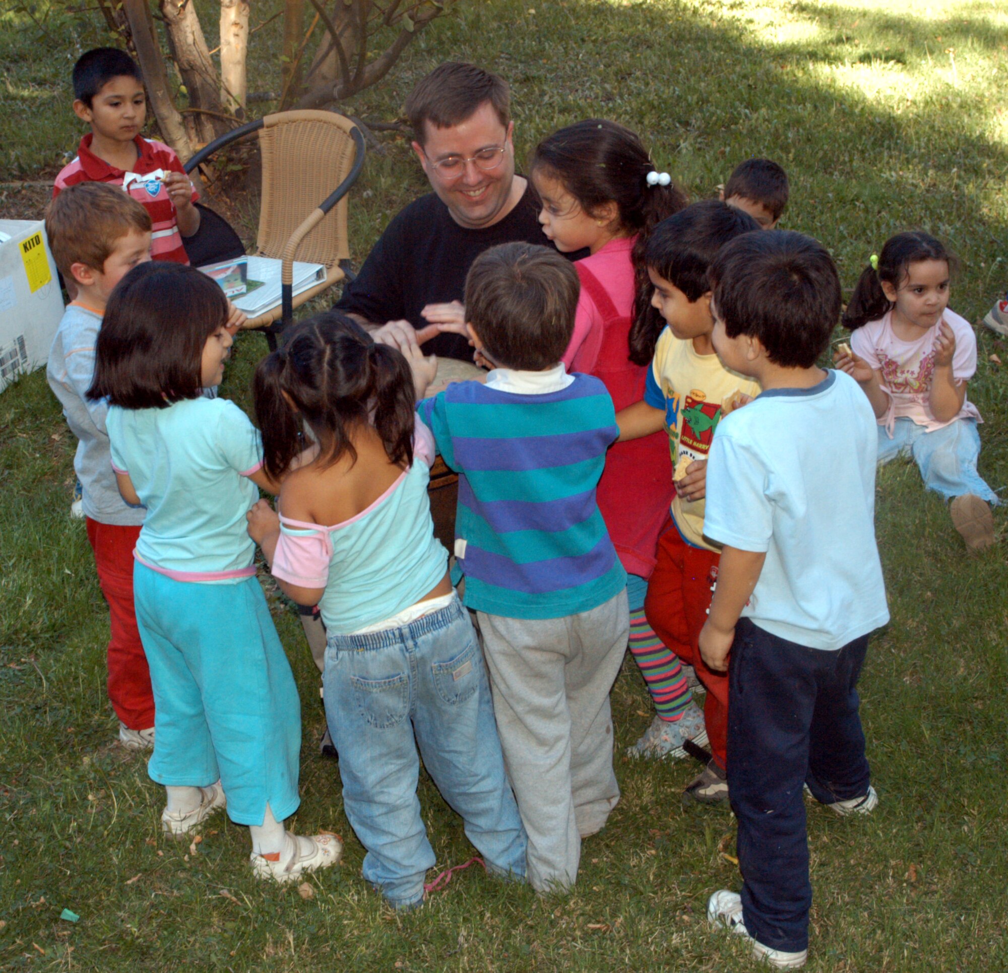SANTIAGO, Chile -- Captain Ruben Olivas, from the Arizona Air National Guard, hands out Girl Scout cookies to children at a local orphanage here Monday, March 31. The captain and about 15 other Airmen took a break from work at FIDAE 2008, an international air show here, to reach out to local community members.  (U.S. Air Force photo/Master Sgt. Jason Tudor)