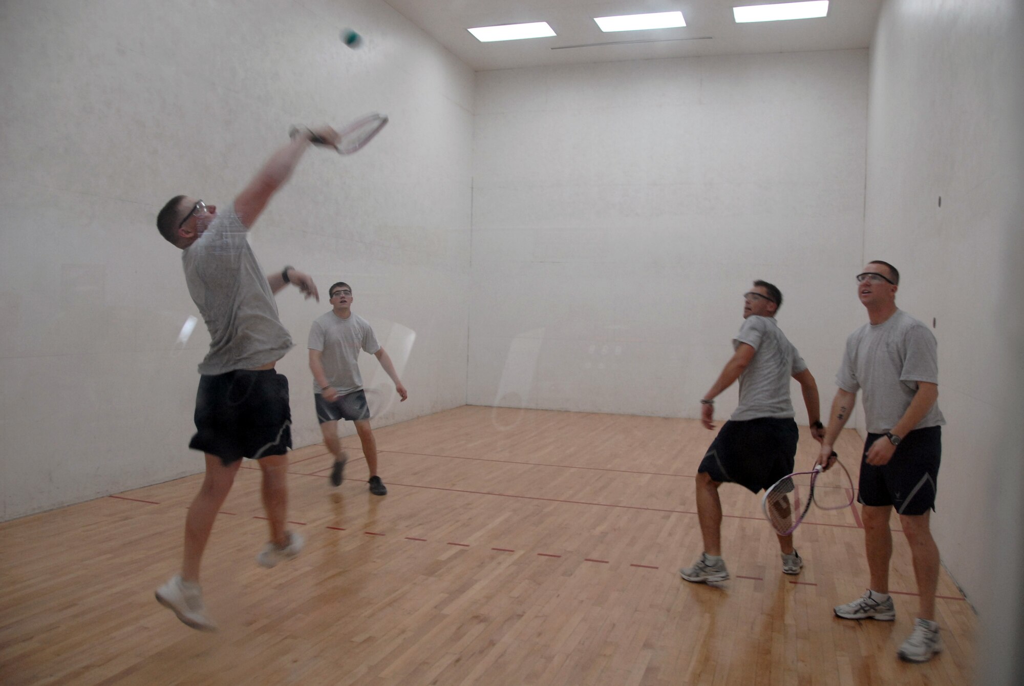 SOUTHWEST ASIA -- Airmen take in a game of racquetball at a military fitness center April 17, 2008, in the Persian Gulf Region. The security forces Airmen are deployed from Moody Air Force Base, Ga., supporting the Global War on Terrorism. (U.S. Air Force photo/Tech. Sgt. Michael O'Connor)