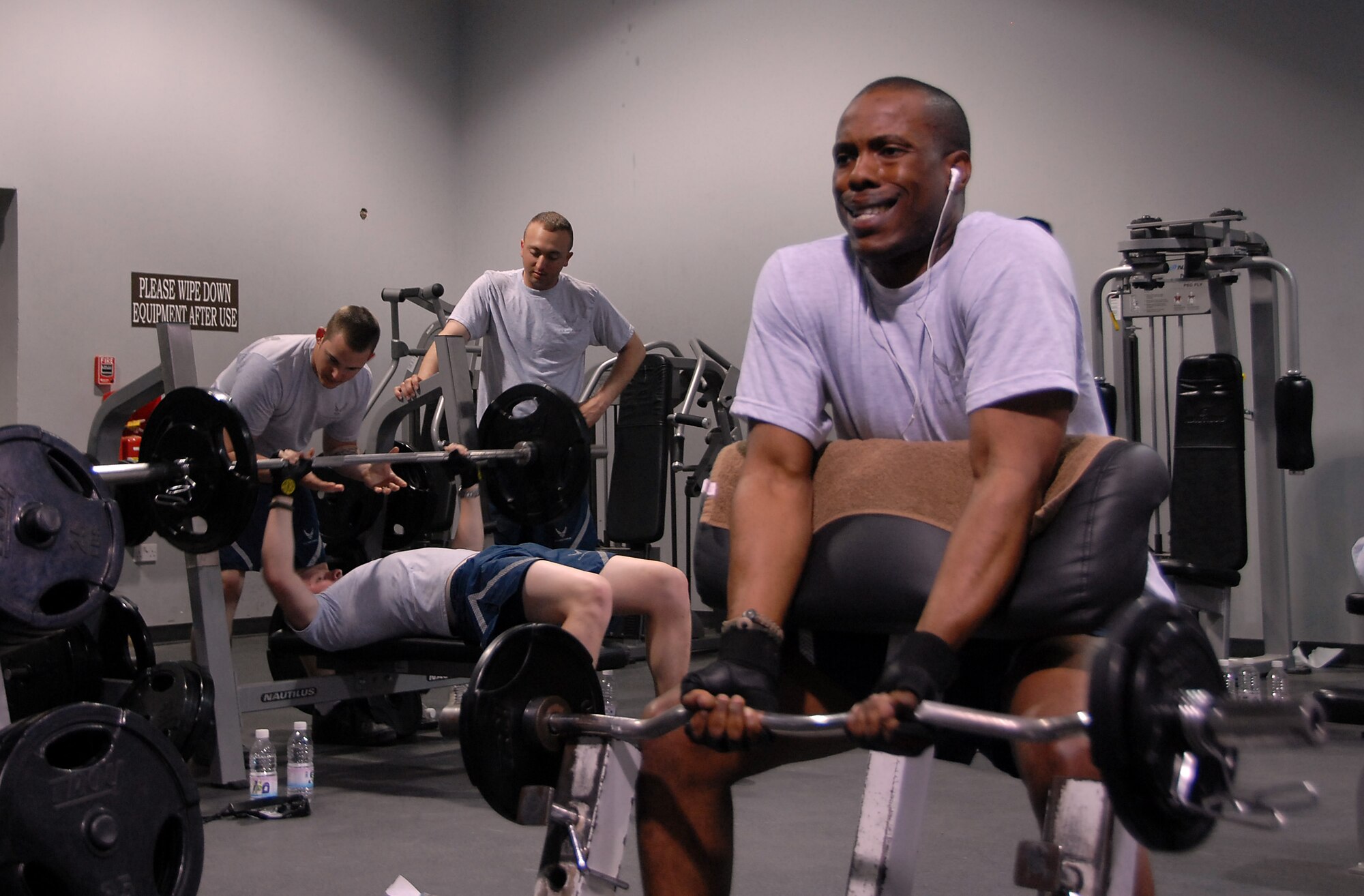 SOUTHWEST ASIA -- Staff Sgt. Jerrme Stanton, 386th Expeditionary Security Forces Squadron, squeezes out another repetition during a set of curls at a military fitness center April 17, 2008, in the Persian Gulf Region. Sergeant Stanton is deployed from the 721st SFS, Cheyenne Mountain Air Force Station, Colo., supporting the Global War on Terrorism. (U.S. Air Force photo/Tech. Sgt. Michael O'Connor)