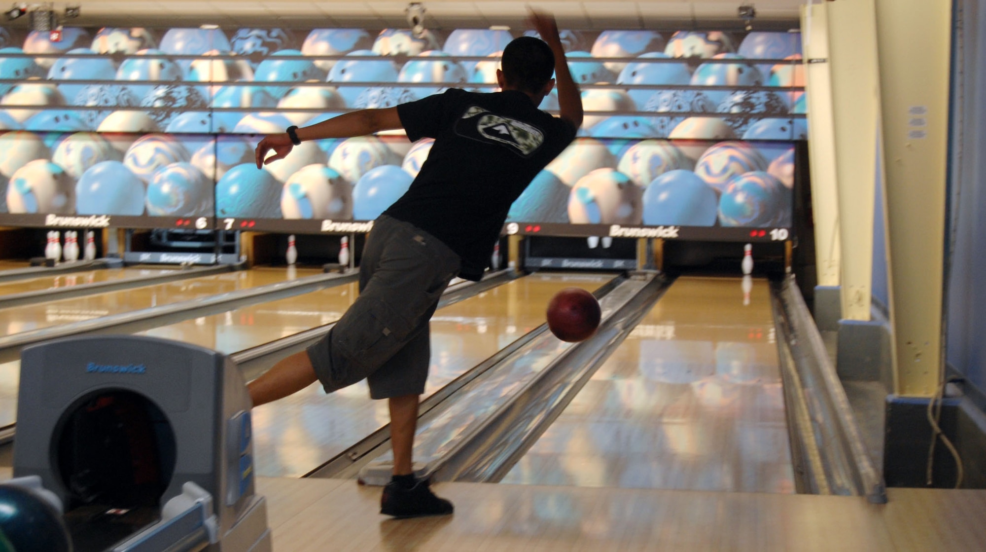 LAUGHLIN AIR FORCE BASE, Texas – Airman 1st Class Francis Nacapuy, 47th Medical Group team member, attempts to pick up a spare during the base bowling tournament at Cactus Lanes April 10. After each team in the tournament played three games, the total pin count was the deciding factor for the champions of the competition.(U.S. Air Force photo by Airman 1st Class Sara Csurilla)
