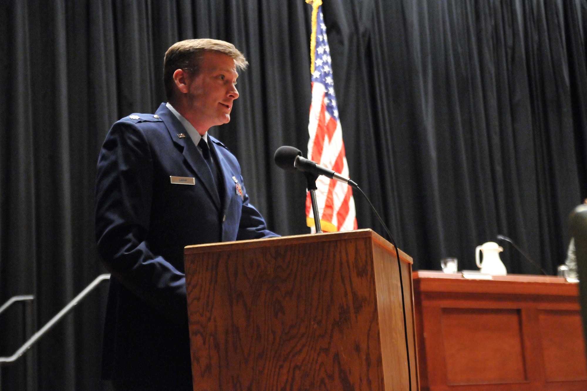 Lt. Col. Sean Sabin, 341st Space Wing staff judge advocate, makes opening remarks before the United States Court of Appeals for the Armed Forces judges entered the auditorium for their "Project Outreach" hearing. The hearing was over the case of the United States vs. Private 1st Class Jeremy T. Wilcox, and was held at the base auditorium here April 10. (U.S. Air Force photo/John Turner)