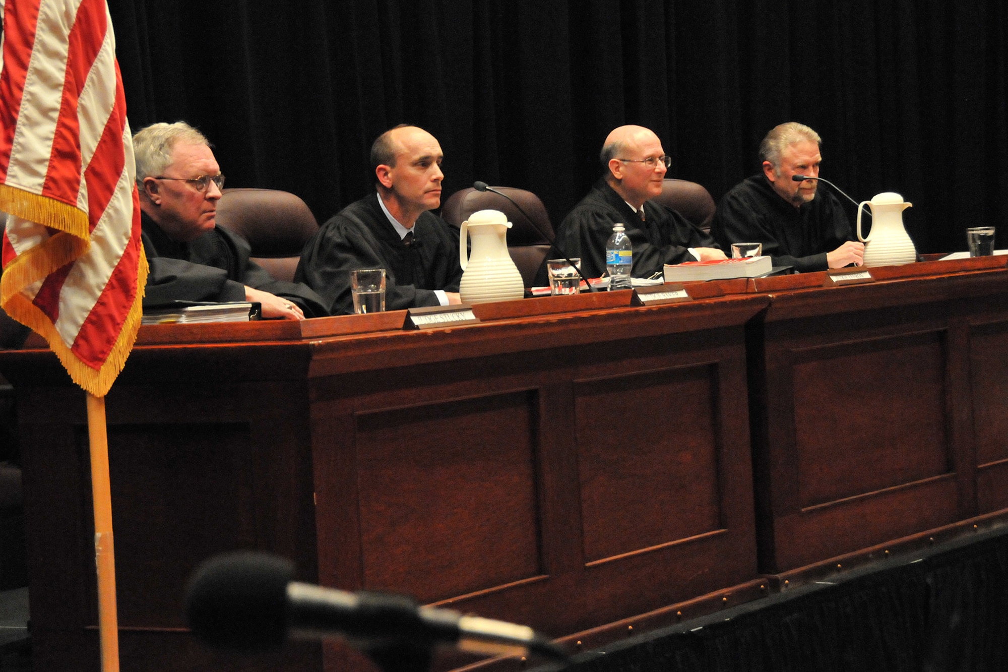 Judge Scott Stucky, Judge James Baker, Chief Judge Andrew Effron and Judge Charles Erdmann listen to presentations made by two Army counsel, one representing the Army and one representing Private Wilcox during a United States Court of Appeals for the Armed Forces "Project Outreach" hearing held at Malmstrom April 10 in the base auditorium. (U.S. Air Force photo/John Turner)