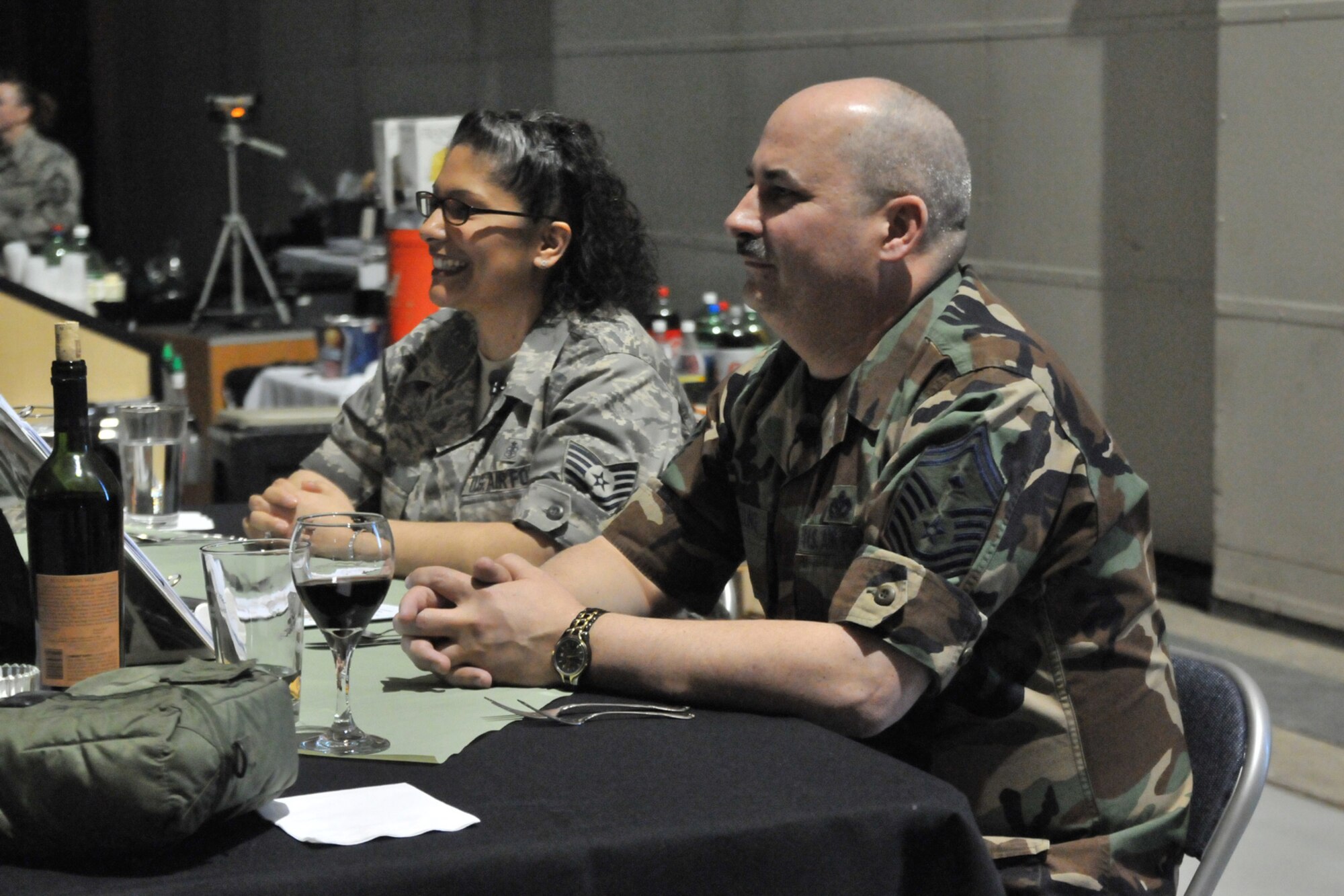 Madame Vice, Tech. Sgt. Judi Baird, 341st Medical Group, and Mister Vice, Senior Master Sgt. Jeffrey Neutzling, 341st Missile Security Forces Squadron, observe the proceedings of the Enlisted Dining Out April 11. Madame and Mister Vice were in charge of sending participants to the Grog Bowl - a concoction of foods and beverages Airmen in attendance had to endure should they have an infraction of the mess. (U.S. Air Force photo/John Turner)