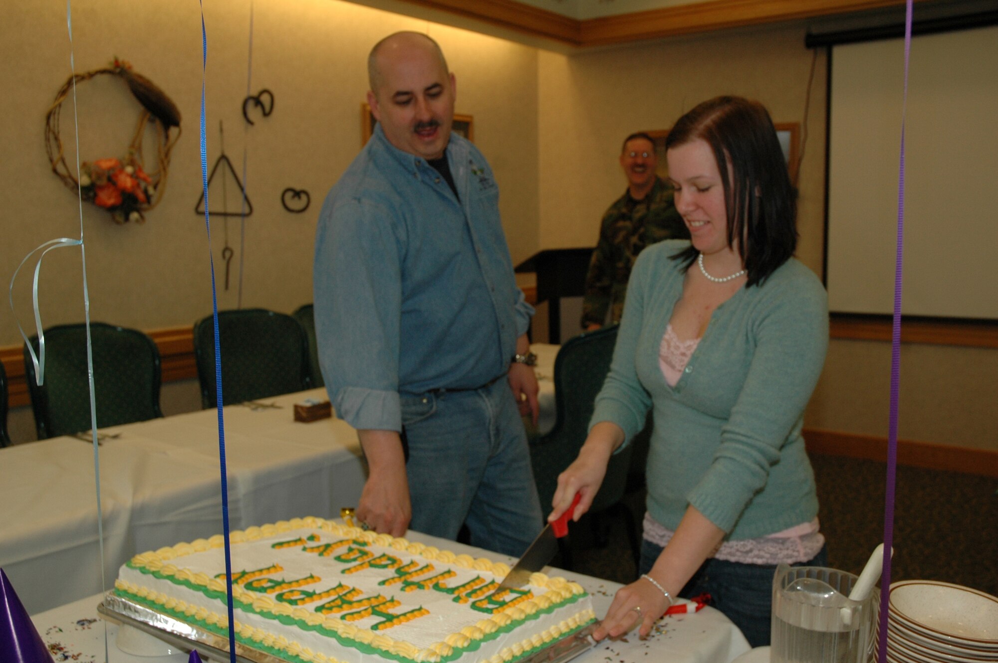 Airman 1st Class Jennifer Sumner, 341st Logistics Readiness Squadron, cuts the birthday cake during the Elkhorn Diner's Birthday Dinner. The event is held bi-annually at the Eklhorn Diner for dorm-dwellers. (U.S. Air Force photo/Airman 1st Class Emerald Ralston)