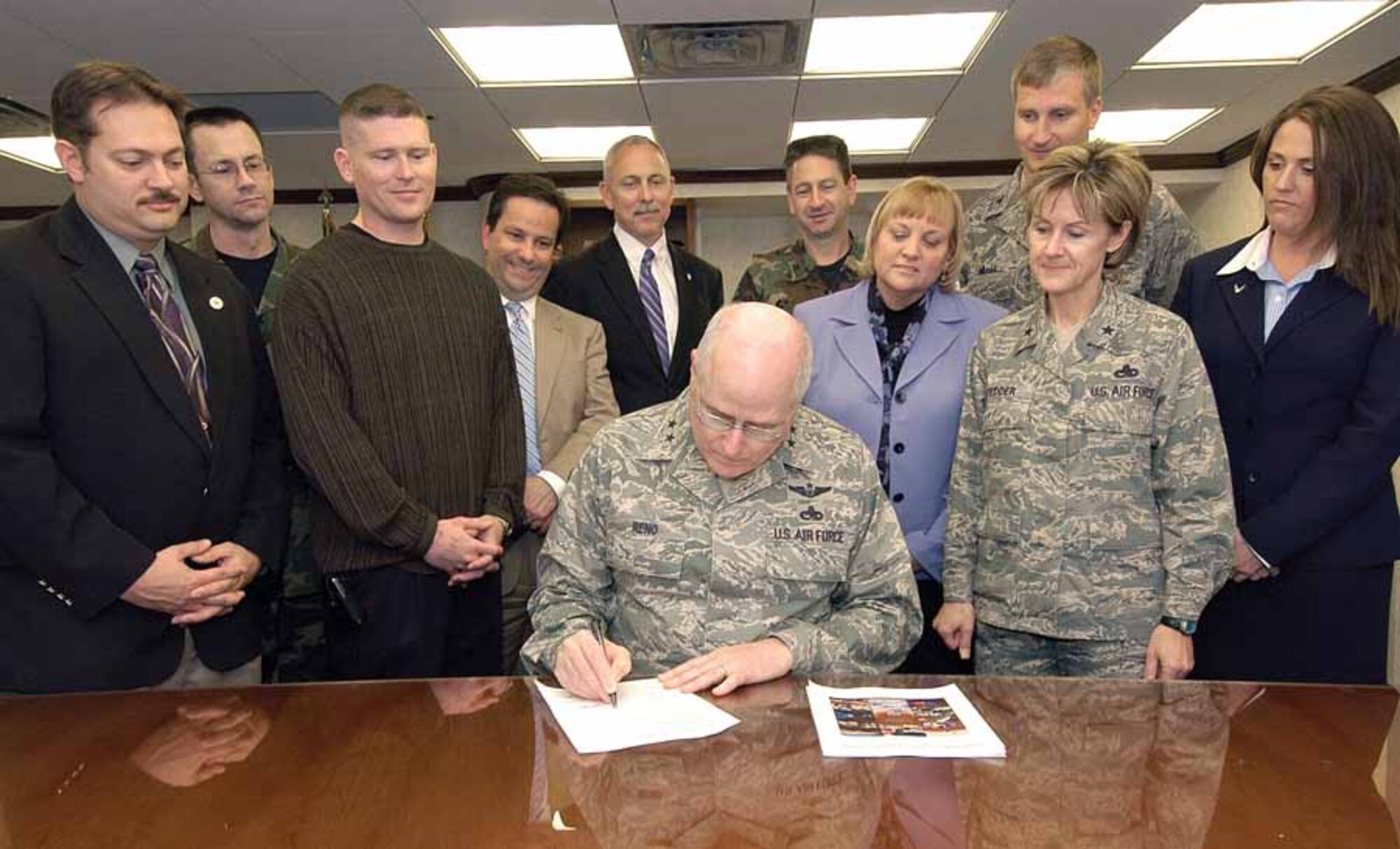 Oklahoma City Air Logistics Center Commander Maj. Gen. Loren Reno adds his signature April 8 to those of other base and union leaders on the OC-ALC Strategic Plan, The plan is a vision and commitment to keep the center focused on the plan’s vision to be the world’s logistics provider of choice.  (Air Force photo by Margo Wright)