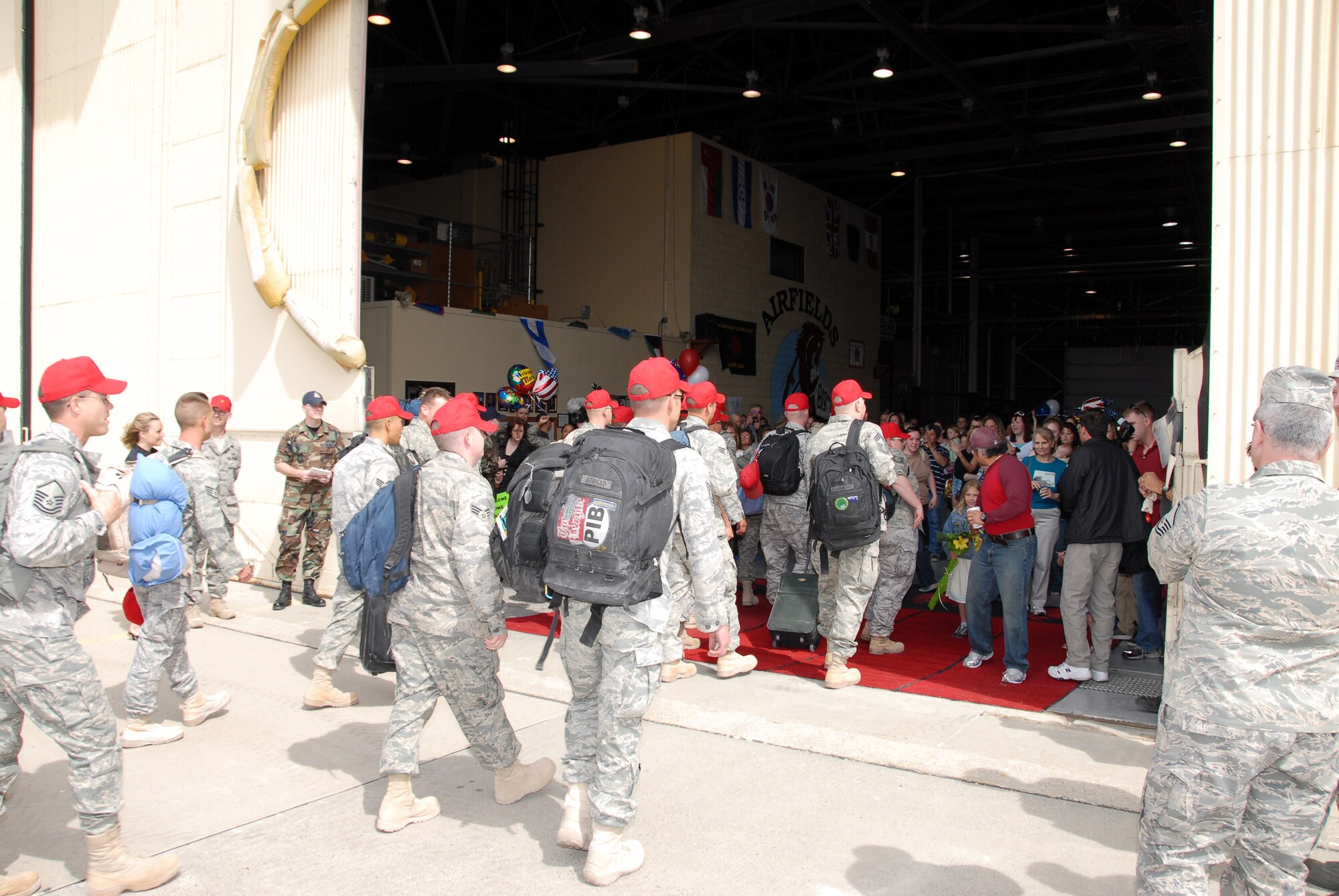 More than 100 members of the 819th RED HORSE Squadron return from a six-month deployment in support of the Global War on Terrorism. They were welcomed by friends and family members at the RED HORSE Hangar at Malmstrom April 14. (U.S. Air Force photo/John Turner)