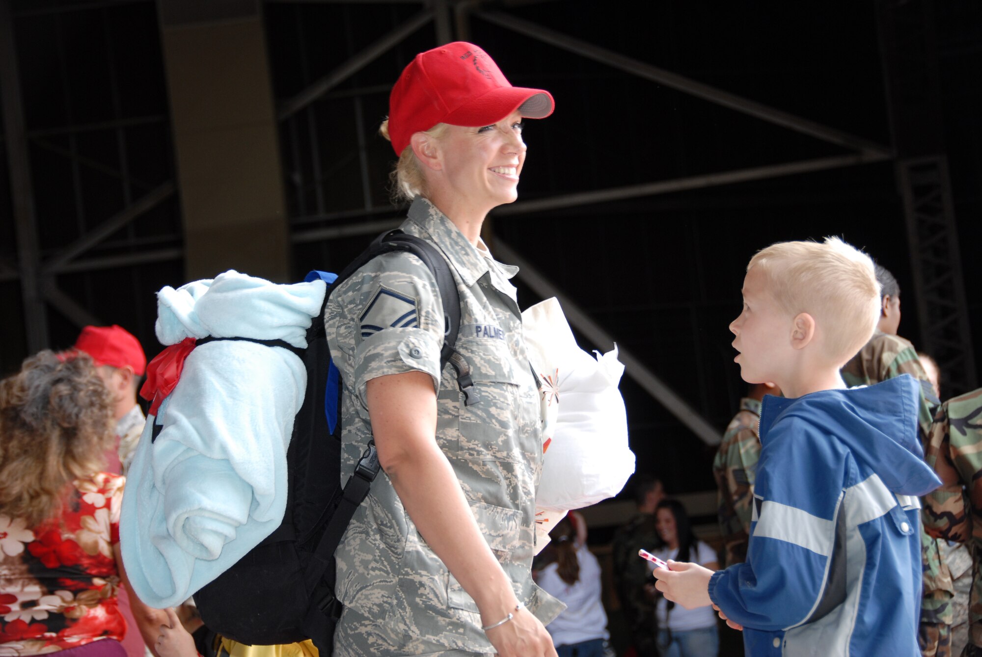 Master Sgt. Kelly Palmer, 819th RHS supply manager, is greeted by her son at the RED HORSE Hangar April 14. Sergeant Palmer was one of more than 100 members of the squadron who deployed for six-months in support of the Global War on Terrorism. (U.S. Air Force photo/John Turner)