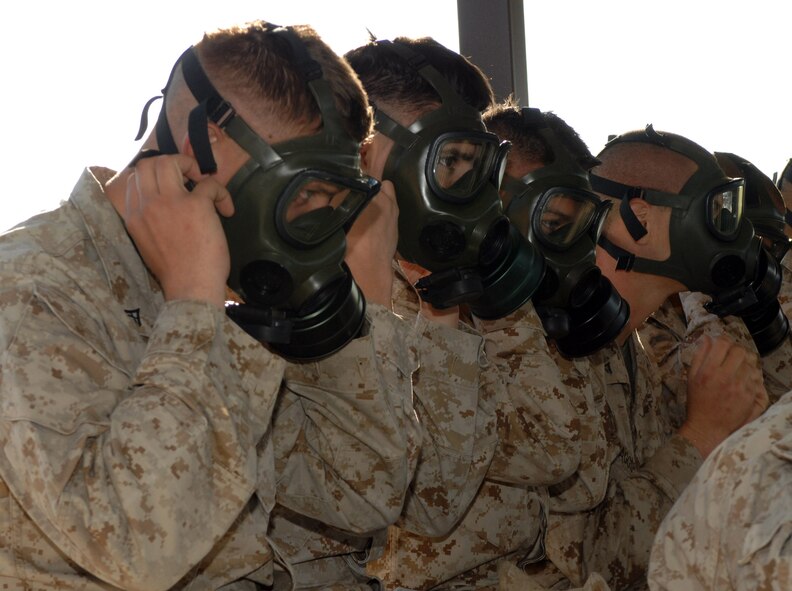 DYESS AIR FORCE BASE, Texas- Marines, Detachment 1, remove their gas mask, April 12. Service Members try on their mask before confidence training to make sure they fit and it has a proper seal. (U.S. Air Force photo by Senior Airman Courtney Richardson)