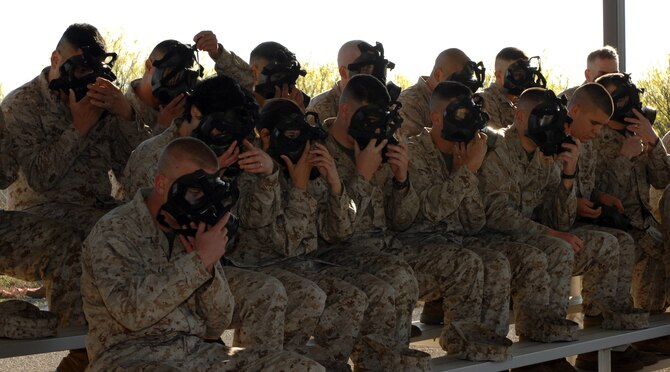 DYESS AIR FORCE BASE, Texas- Marines from Detachment one, size up their gas mask, April 12. Service members fit their gas mask to their face tightly to ensure a proper seal. (U.S. Air Force photo by Senior Airman Courtney Richardson)