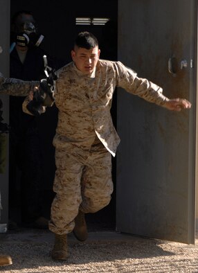DYESS AIR FORCE BASE, Texas- Lance Corporal Gergorio Herrandez, Detachment 1,  lunges out of the gas chamber, April 12. The physical effects of tear gas are burning sensation, difficulty breathing, and sinus discharge. (U.S. Air Force photo by SrA Courtney Richardson)