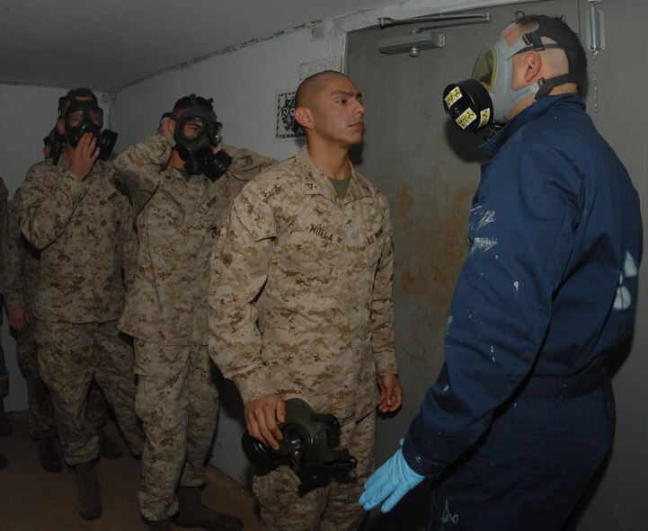 DYESS AIR FORCE BASE, Texas- Lance Corporal Roberto Muela, Detachment 1, awaits a question while inhaling tear gas in the gas chamber, April 12. The Marines are required to answer a question given by the instructors before exiting the chamber to ensure that they get the full affect of the gas. (U.S. Air Force photo by Senior Airman Courtney Richardson)
