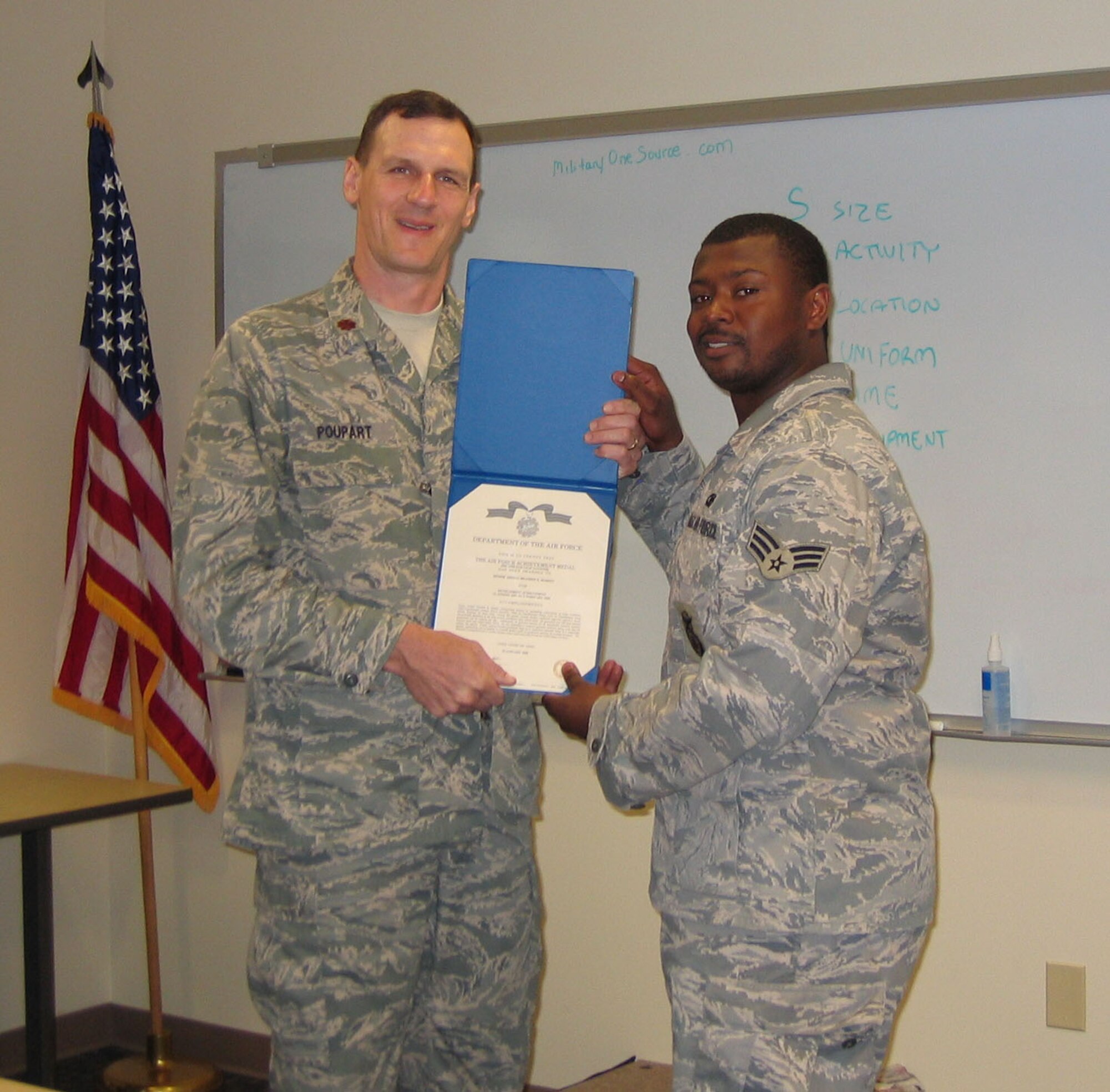 SEYMOUR JOHNSON AIR FORCE BASE, N.C. -- Senior Airman Brandon Burden (right) receives the Air Force Achievement Medal Second Oak Leaf Cluster from his commander, Maj. Jeff Poupart. Airman Burden is a fire team member with the 916th Security Forces Squadron. U.S. Air Force photo/SrA Veronica Odom