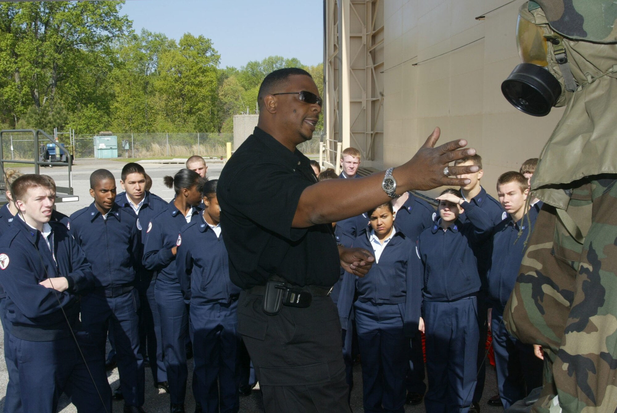 Wayne Jones, of the 94th Civil Engineer emergency management office, briefs Junior Reserve Officer Training Corps cadets from Sequoha High School on the importance and uses  of the chemical suit. Along with orientation flights, the students saw career displays and spoke with recruiters. (Air Force photo/Don Peek)