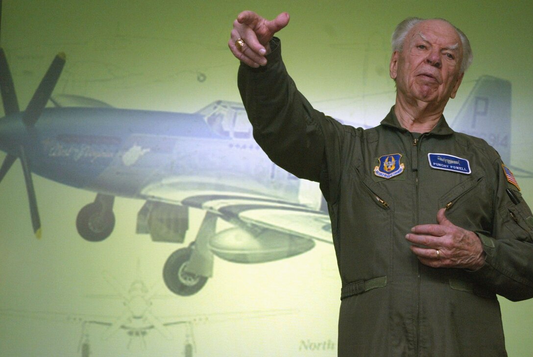 Retired Air Force fighter pilot, Bob "Punchy" Powell, visited the 700th Airlift Squadron and shared his experiences and stories of other pilots that flew against the Germans in World War II. He also signed copies of his book, "Bluenoser Tales," about the exploits of the 352nd Fighter Group that flew out of Bodney Airfield in England. Powell was here to support the Air Warrior Program. The 700th Airlift Squadron sponsors the program to motivate and instill a warrior spirit, said Maj. Todd Copley, assistant operations officer and part-time historian. (Air Force photo/Don Peek)