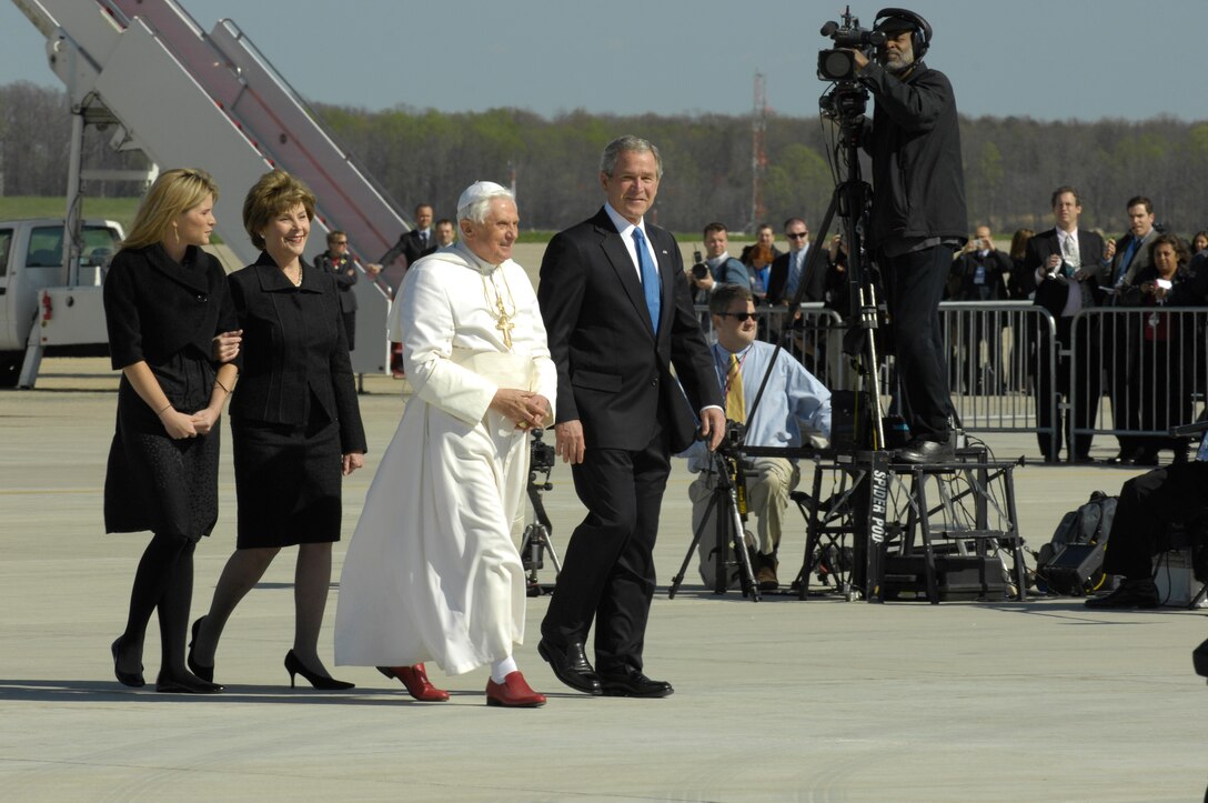 Pope Benedict XVI walks with President George W. Bush upon his arrival at Andrews Air Force Base, Md., hosted by the 316th Wing and the Air Force District of Washington, Apr 15, 2008, beginning his weeklong trip to the United States.  The Pontiff, selected 265th pope on April 19, 2005, will meet with President George W. Bush at the White House, address the presidents of Roman Catholic Colleges and Universities, and hold mass at Nationals Park in Washington D.C. and Yankee Stadium in New York City.
   (U.S. Air Force photo by Senior Airman Renae L. Kleckner)(released)