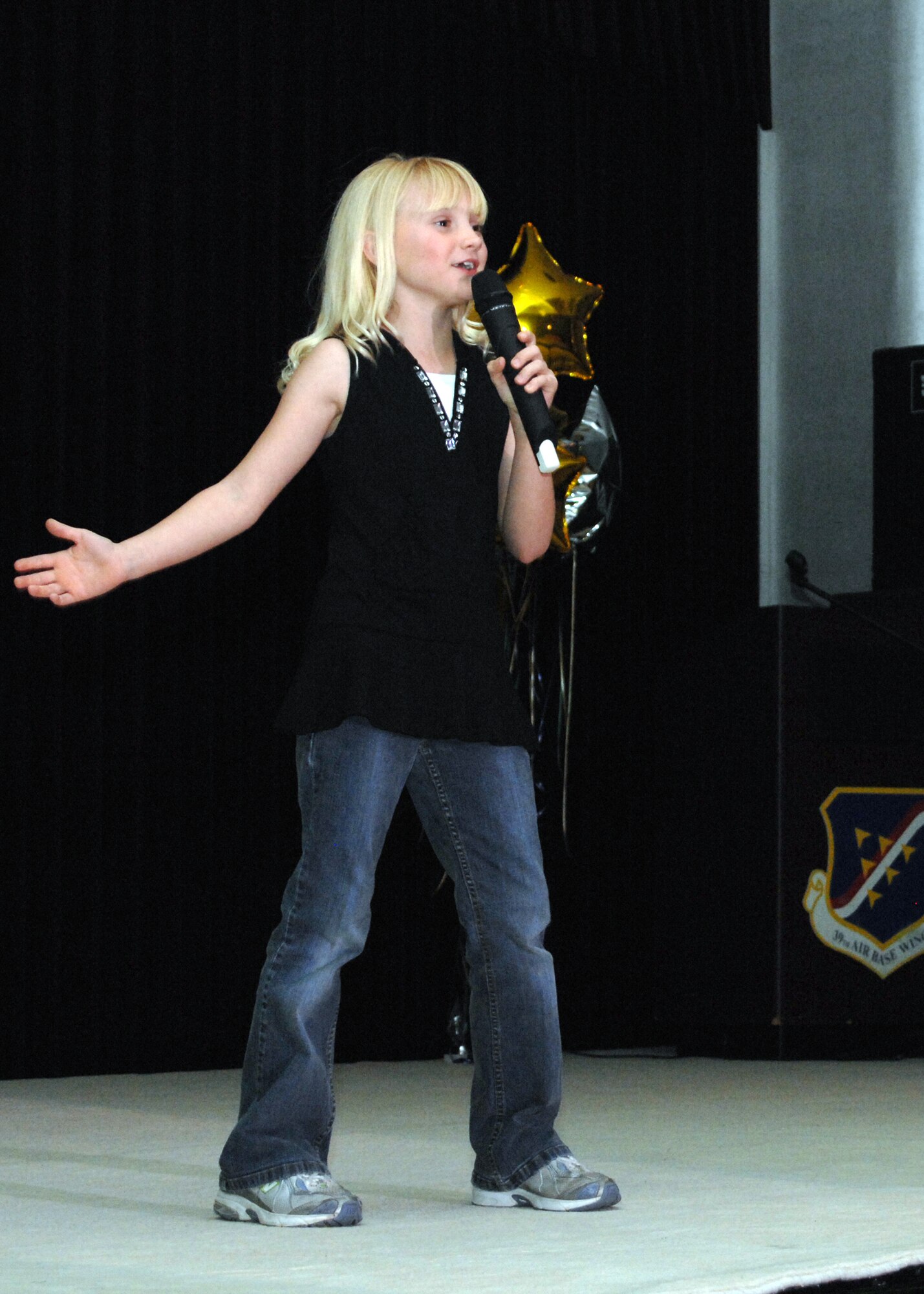 Emma Daniels sings "What Dreams Are Made Of" by Hilary Duff, and won second place Female Vocalist for the 6-11 age group. The goal of the USAFE Talent Contest is to help youth develop talents and skills in the performing arts by providing professional instructions and direction. (U.S. Air Force photo by Senior Airman Jason Burton)