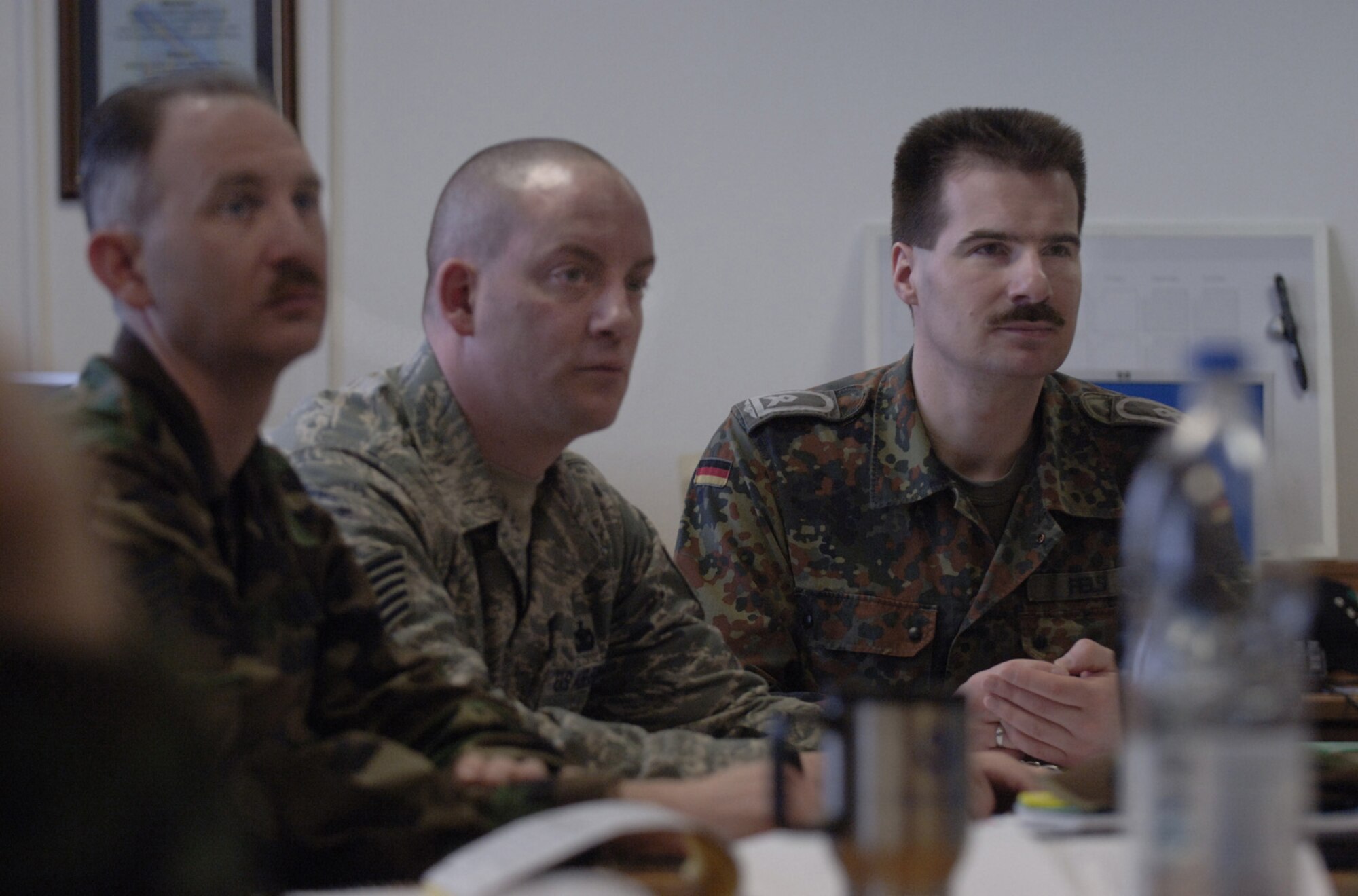 In their fifth week of study at the Kisling Noncommissioned Officer Academy at Kapaun Air Station, Germany, German Air Force Master Sgt. Holger Fels and Tech. Sgt. Eric Corriveau (center) listen to a lecture about involving subordinates in the process of problem sovling. Sergeant Fels, a German NCO Academy instructor in Appen, Germany, voluntarily enrolled in the six-week course to prepare for a four-year special duty assignment assignment as an exchange instructor at the Senior NCO Academy at Maxwell Air Force Base, Alabama. Photo by Master Sgt. Scott Wagers