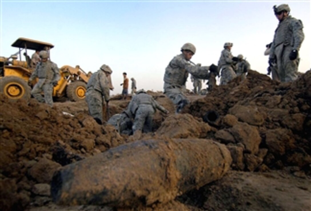 U.S. soldiers excavate a large weapons cache at a scrap yard in Jabr al-Ansari, Iraq, April 14, 2008. The cache was found due to a tip from the Sons of Iraq. The soldiers are assigned to the 3rd Infantry Division's, 3rd Squadron, 1st Cavalry Regiment, 3rd Brigade Combat Team. 