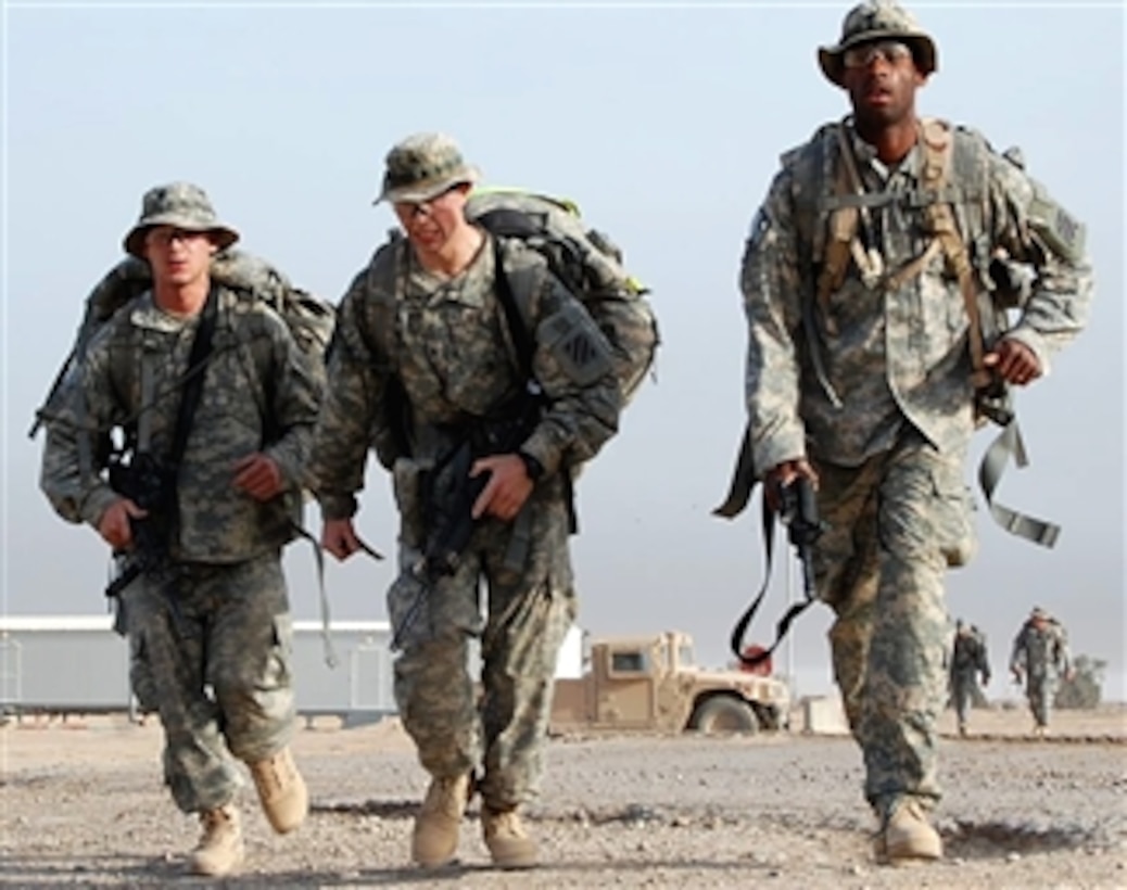 U.S. soldiers complete the foot march portion of the "Eagle Challenge," Forward Operating Base Hammer, Iraq, April 6, 2008. The soldiers, assigned to 3rd Infantry Division's 203rd Brigade Support Battalion, tested their physical and mental stamina with the annual drill. 