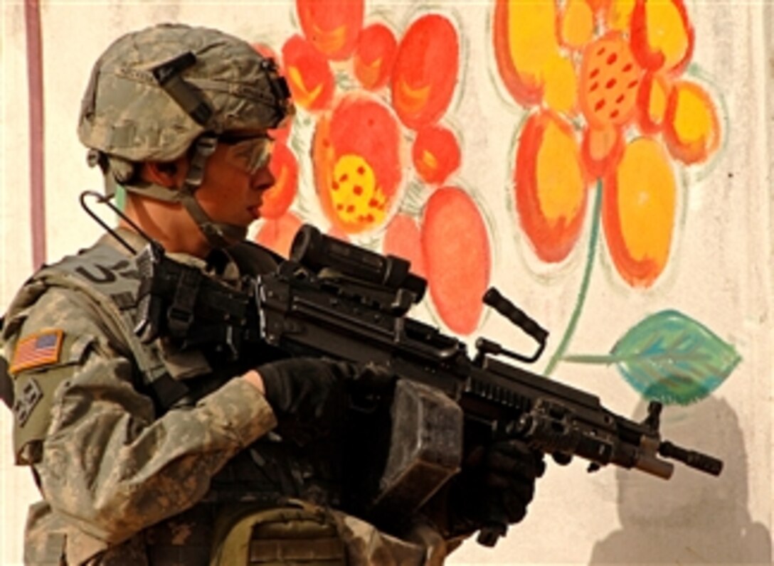 U.S. Army Pvt. Chrisman provides security as U.S. Army soldiers make an assessment of a market in Mosul, Iraq, April 15, 2008. Chrisman is assigned to the 4th Infantry Division's 1st Battalion, 8th Infantry Regiment.