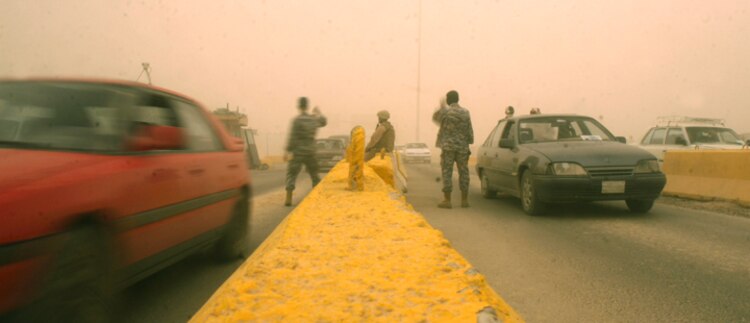 Iraqi Police and guards perform vehicle searches and control the flow of traffic through entry control point 1, here April 17. While Marines remain at ECPs, they maintain an overwatch position for the Iraqis, who are working at providing security for themselves.