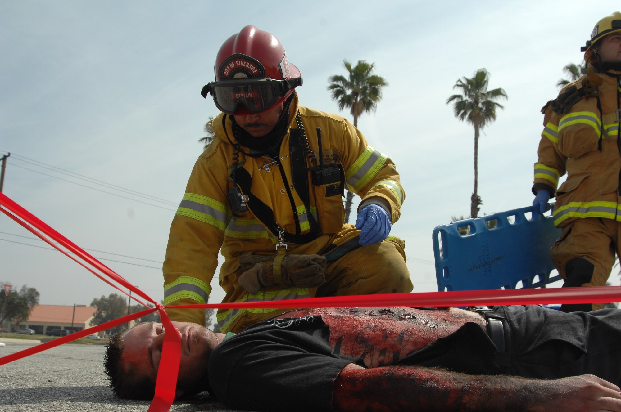 A City of Riverside firefighter assesses a victim's condition to get him ready to be transported to a medical facility.  Several local hospitals also participated in the exercise held at March Air Reserve Base, California. An emergency medical crew from Mercy Air airlifted simulated casualties. Some one hundred disaster responders and injured actors participated in a mass casualty exercise held on the flight line at the base. The exercise involved several community partners, such as Riverside EMS, AMR and Mission ambulance. (U.S. Air Force photo by 4th CTCS)