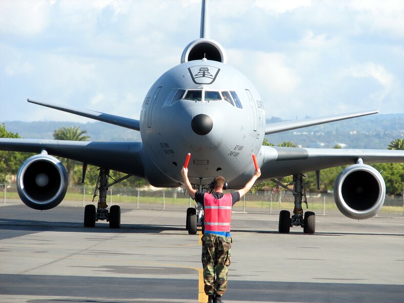 HICKAM AIR FORCE BASE, Hawaii -- An Airrman from the 735th Mobility Squadron at Hickam AFB guides a Air Mobility Command KC-10 to a parking spot. The squadron  earned an overall 'Outstanding' rating during a recent Logisitics Standardization Evaluation Program (LSEP) inspection here. (U. S. Air Force photo/courtesy 735 AMS)