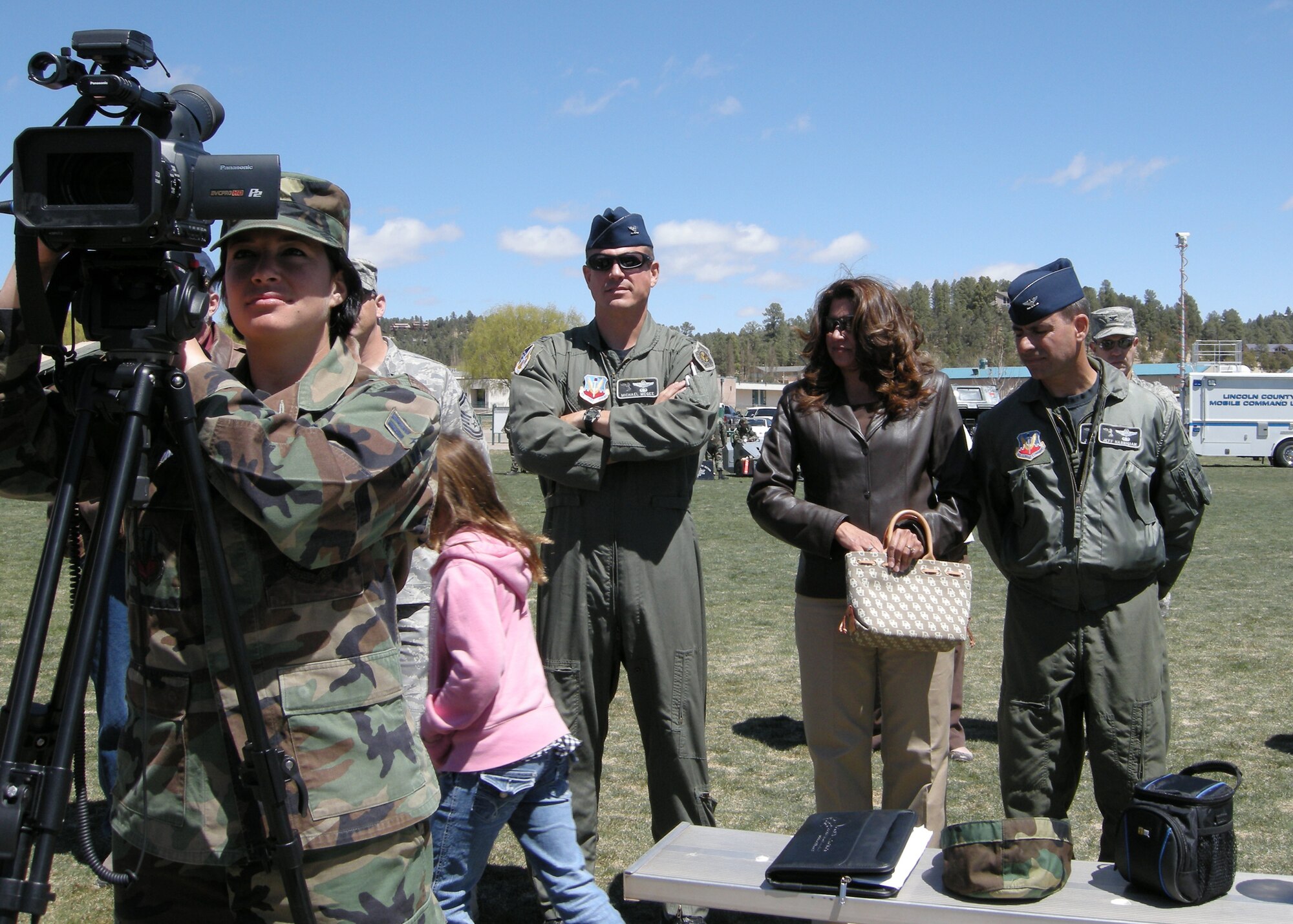RUIDOSO, N.M.-- Airman 1st Class Katerina Slivinske, 49th fighter wing public affairs documents the honor guard during the Military Appreciation Weekend while Colonel Michael McGee, 49th fighter wing vice commander, 49th fighter wing commander Colonel Jeff Harrigian and his wife Kathy standby here Apr. 12. (U.S. Air Force photo by Captain Rodney McNany)