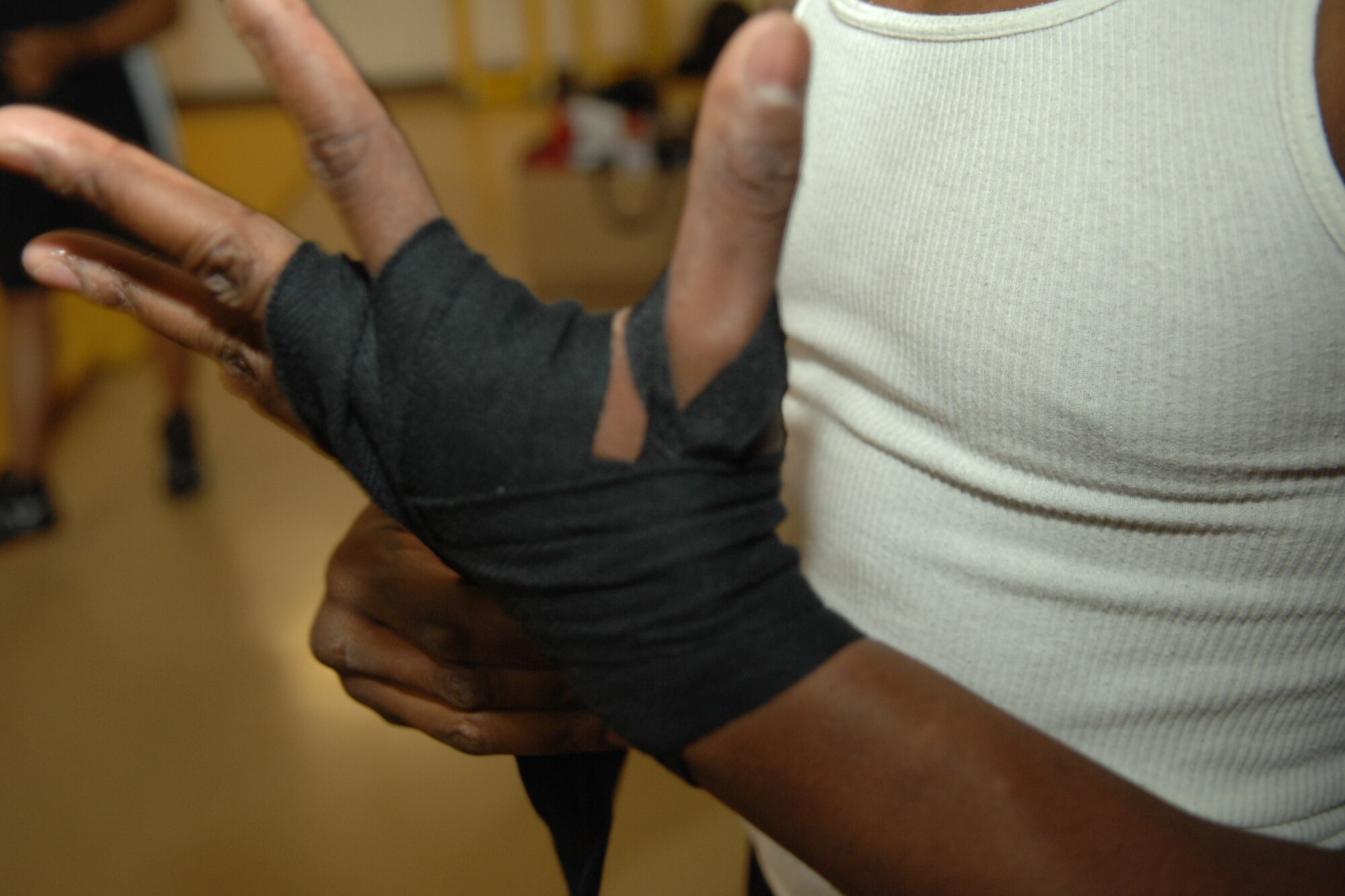 HOLLOMAN AIR FORCE BASE, N.M. -- Airman 1st Class Gabriel Lewis, 49th Security Forces Squadron, wraps his hand during boxing practice at the Sports and Fitness Center here. Airman Lewis, who is fairly new to the sport, has been interested in boxing for some time and is excited about having the opportunity to become a better fighter. (U.S. Air Force photo/Airman 1st Class Jamal D. Sutter)