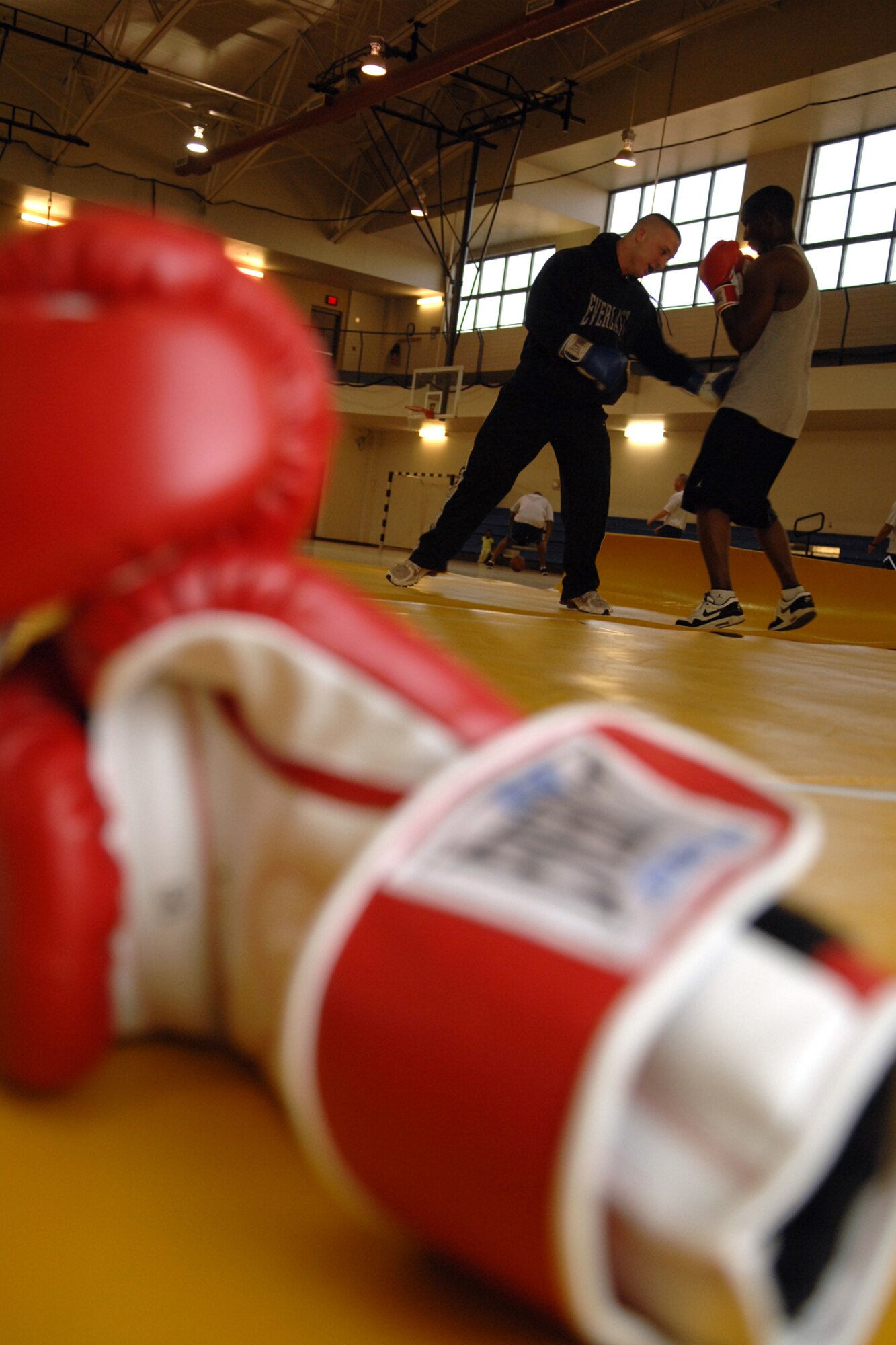 HOLLOMAN AIR FORCE BASE, N.M. -- Senior Airman Thomas McConnell, boxing coach, and Airman 1st Class Daniel Monroe, 49th Operations Support Squadron, work on techniques during boxing practice at the Sports and Fitness Center here. Airman McConnell established the boxing club in August of last year. (U.S. Air Force photo/Airman 1st Class Jamal D. Sutter)