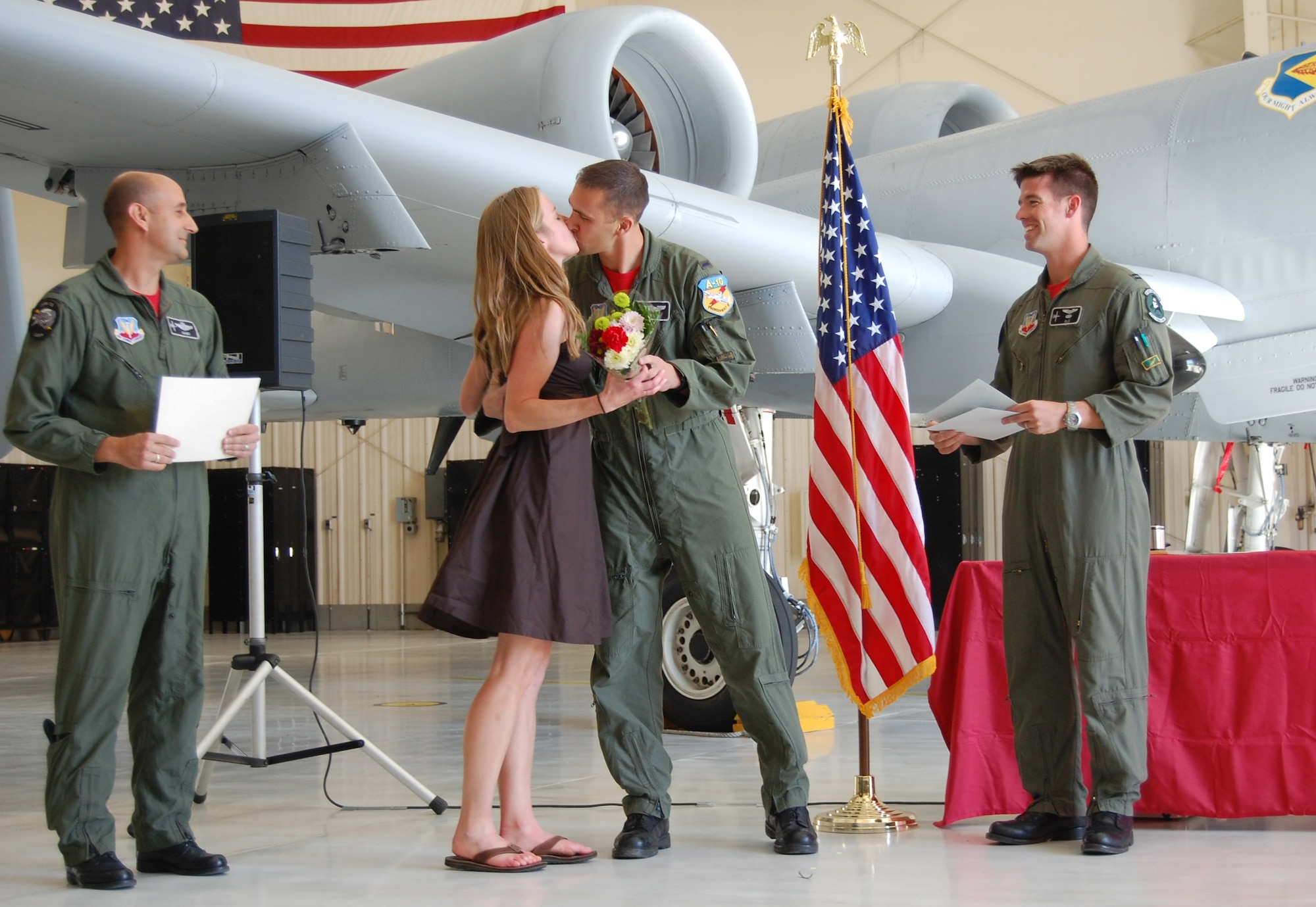 Initial A-10 qualification course graduate, 1st Lt. Ryan “Fonix” Brown, shares a kiss with his wife, Debbie, before receiving his certificate at the class 08-ABD graduation at Davis-Monthan April 11. Lieutenant Brown, who graduated with 11 other pilots at the 358th Fighter Squadron "Lobos" hangar, will be assigned to the 190th Fighter Squadron, Idaho Air National Guard. (U.S. Air Force photo by 2nd Lt. Mary Pekas)