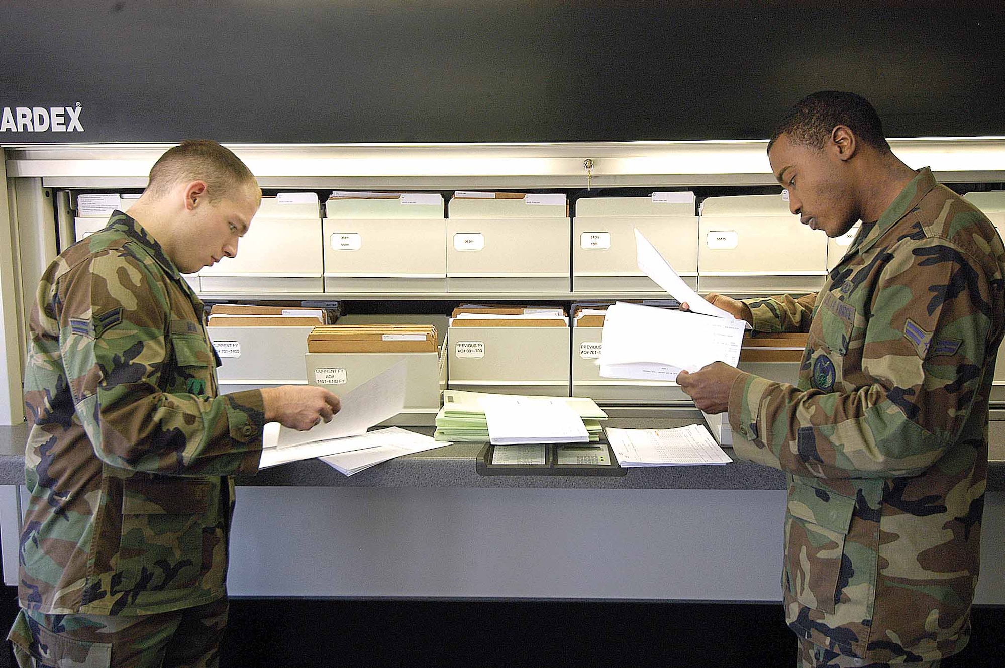 Airmen 1st Class Andrew Mohr, left, and Justin Wilson review some of the 2,000 records managed in the Flight Records Office of the 72nd Operational Support Squadron.  (Air Force photo by Margo Wright)
