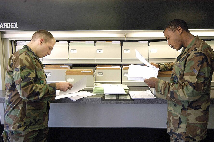 Airmen 1st Class Andrew Mohr, left, and Justin Wilson review some of the 2,000 records managed in the Flight Records Office of the 72nd Operational Support Squadron.  (Air Force photo by Margo Wright)
