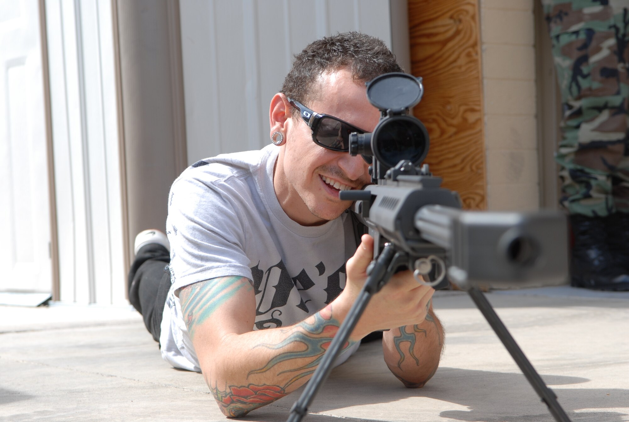 Linkin Park's lead singer, Chester Bennington, focuses his sight on his target during a tour of Luke April 1.