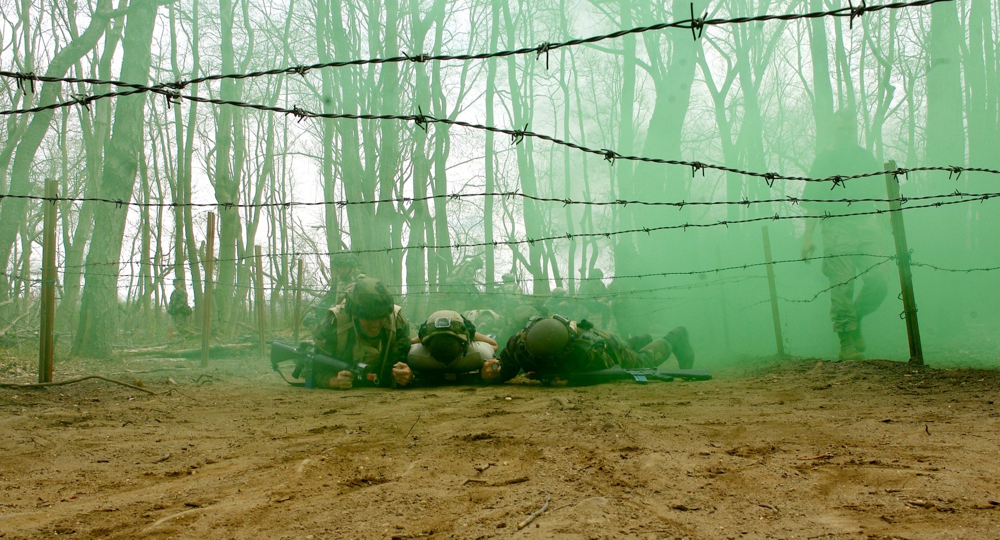 Senior Master Sgt Robert Mayor (right) and 1st Lt Brandon Vigneron (left), both students  in Advanced Contingency Skills Training Course 08-4, attempt to low crawl under barbed wire with a simulated wounded patient to a safe area during the combat first aid portion of the ACST course on a Fort Dix, N.J., range April 11, 2008. The course is taught by the U.S. Air Force Expeditionary Center's 421st Combat Training Squadron and prepares Airmen for upcoming deployments. (U.S. Air Force Photo/Staff Sgt. Samuel Rogers)