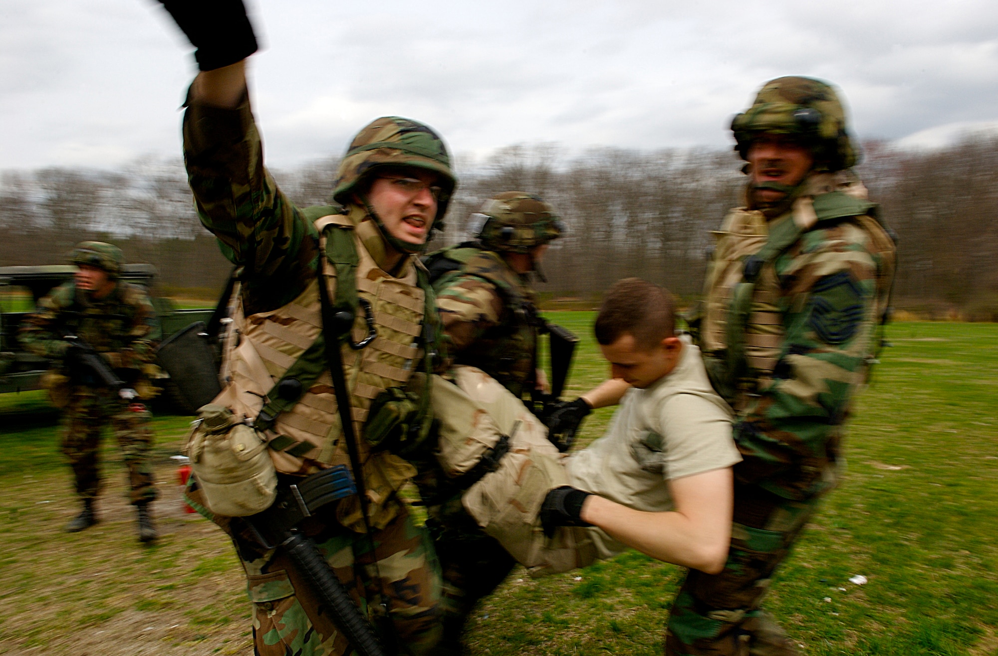 Staff Sgt. Benjamin Kramer (left), Senior Master Sgt. Robert Mayor (right) and 1st Lt. Brandon Vigneron (rear right), all students  in Advanced Contingency Skills Training Course 08-4, carry a simulated wounded patient to a safe area during the combat first aid portion of the ACST course on a Fort Dix, N.J., range April 11, 2008. (U.S. Air Force Photo/Staff Sgt Samuel Rogers)
