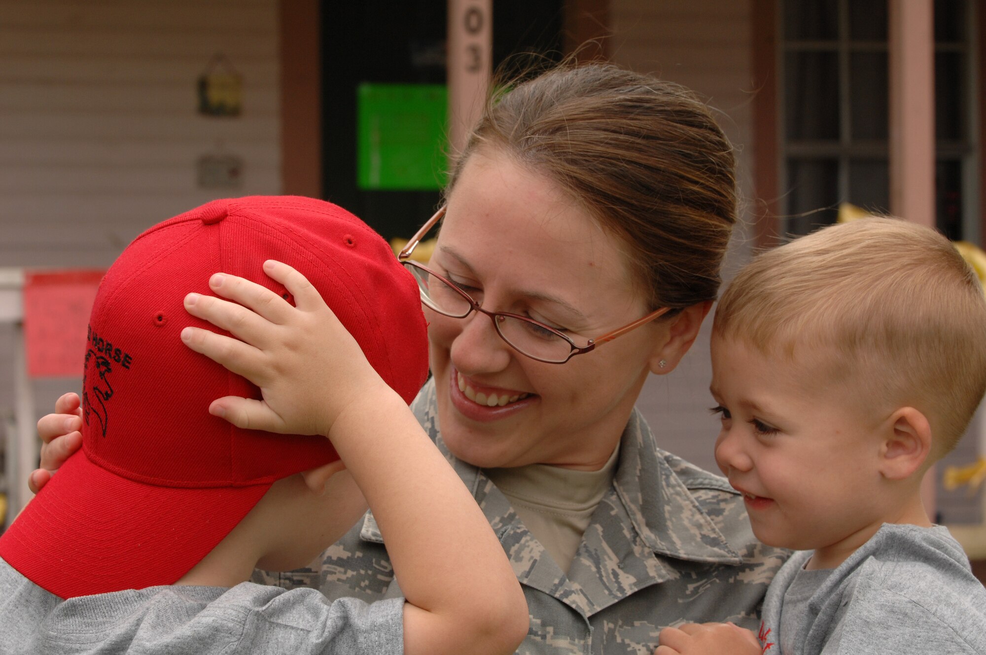 Staff Sgt. Cynthia Karch of 307th RED HORSE Squadron holds her sons Cameron and Case in Hawkins, Texas, on April 17th. A parade and award presentation was held for Sergeant Karch and Tech. Sgt. Michael McComb who are both members of RHS recently returned from Iraq and residents of Hawkins.  (U.S. Air Force photo by Airman 1st Class Joanna M. Kresge)