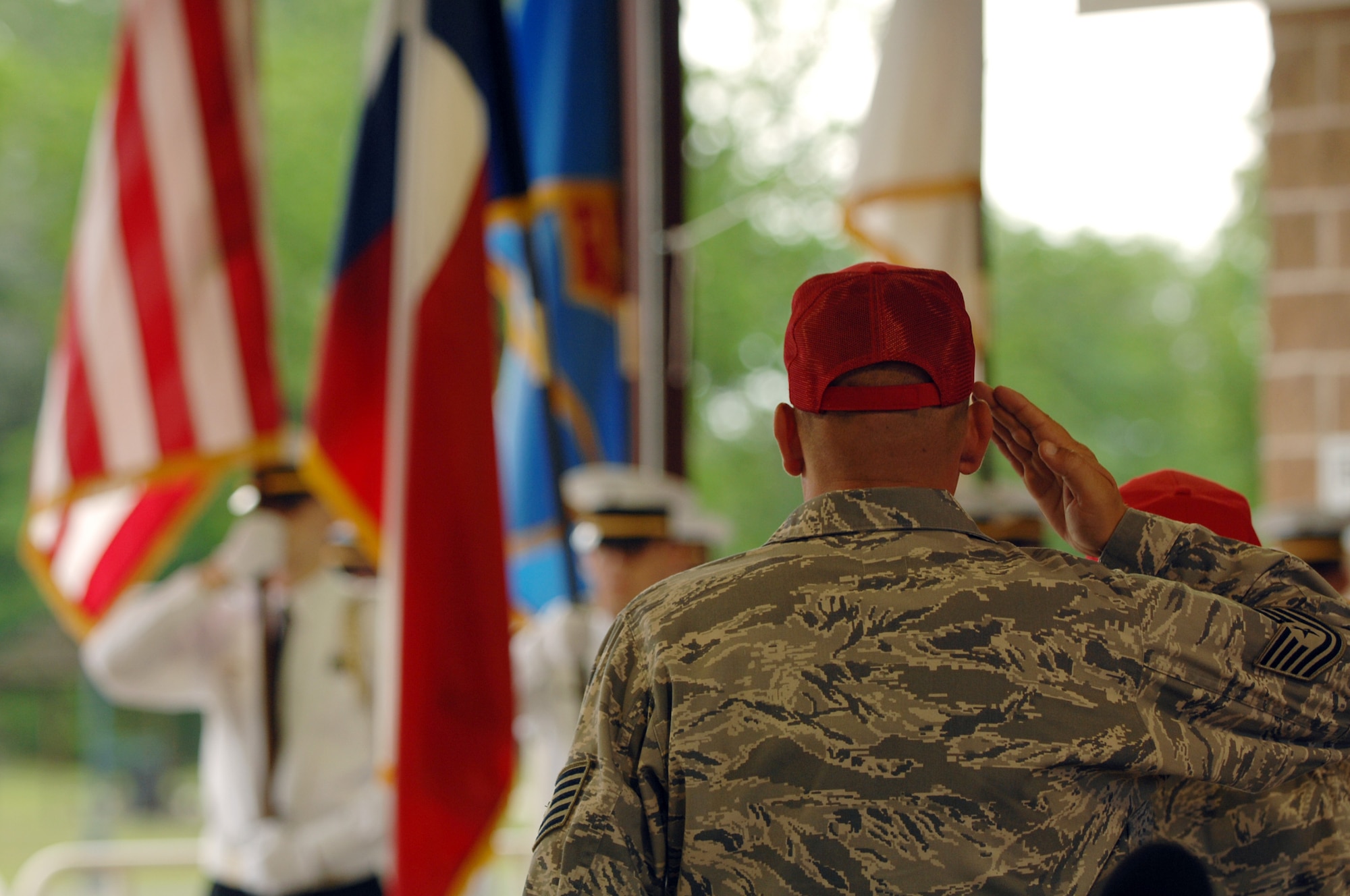 Tech. Sgt. Michael McComb of 307th RED HORSE Squadron salutes the flag of the United States during the playing of the national anthem in Hawkins, Texas, on April 17th. A parade and award presentation was held for Sergeant McComb and Staff Sgt. Cynthia Karch who are both members of RHS recently returned from Iraq and residents of Hawkins. (U.S. Air Force photo by Airman 1st Class Joanna M. Kresge)