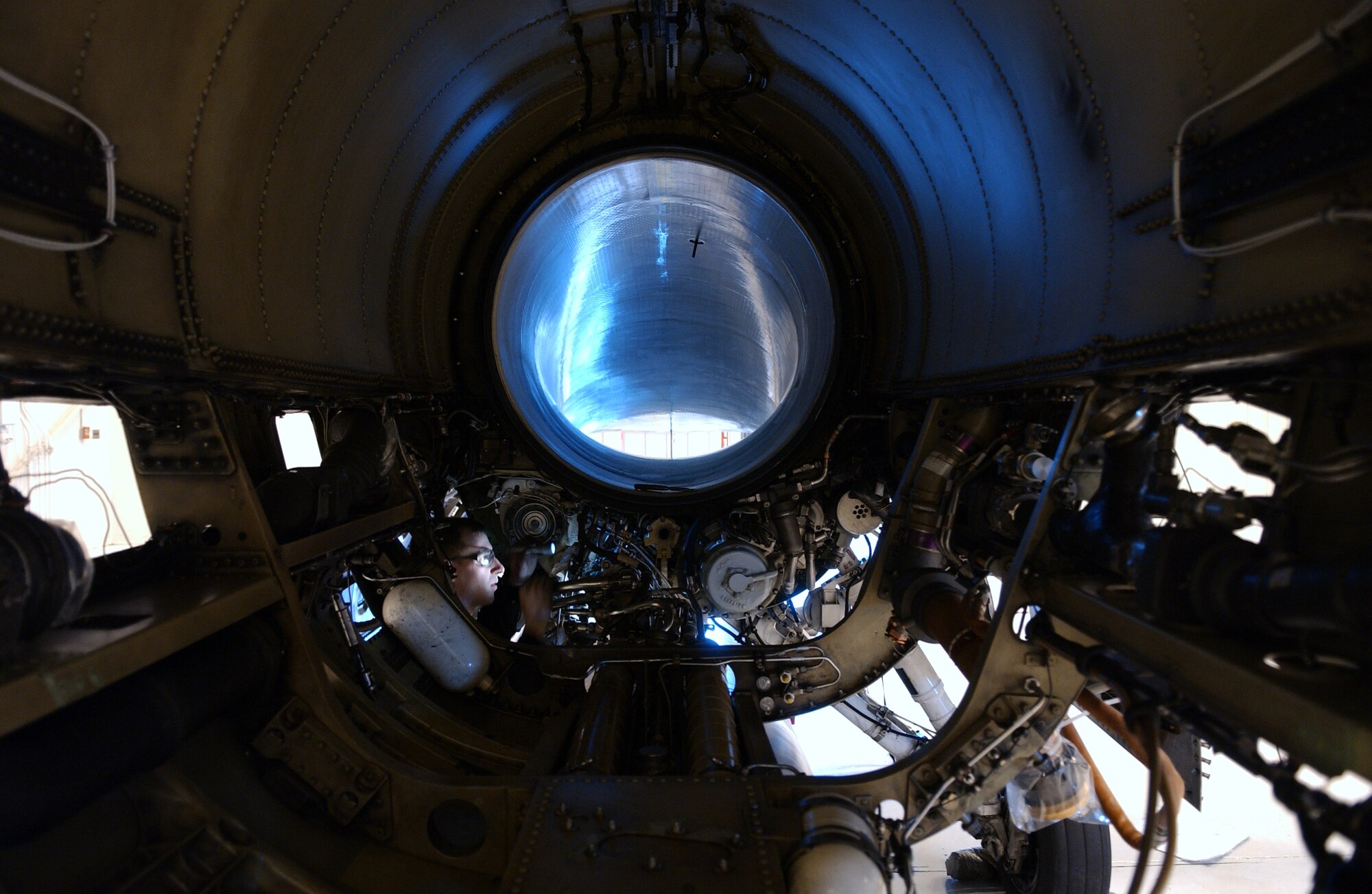 Airman 1st Class Clinton Gessler conducts an engine bay inspection on a F-16 Aggressor, April 15, 2008, at Eielson Air Force Base, Alaska. Every 200 hours of use the engine will be inspected, if it fails inspection they will pull it out and thoroughly gone through. The 354th Aircraft Maintenance Squadron is responsible for maintaining the F-16 Aggressors of the 18th Aggressor Squadron enabling them to be mission ready. He is a crew chief assigned to the 354th AMXS. (U.S. Air Force Photo/Airman 1st Class Jonathan Snyder)