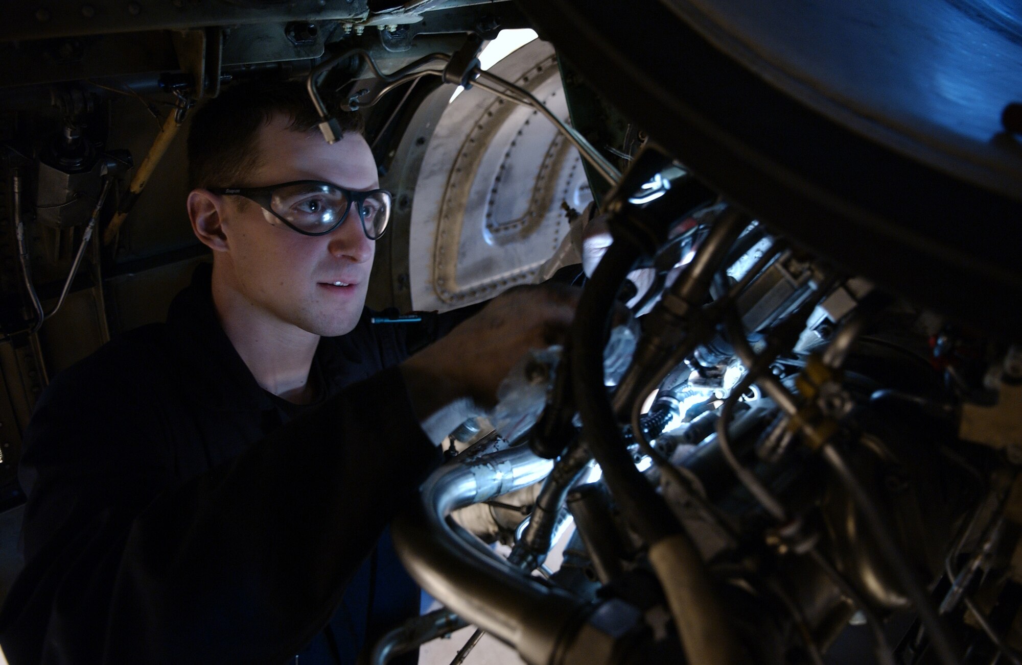 Airman 1st Class Clinton Gessler conducts an engine bay inspection on a F-16 Aggressor, April 15, 2008, at Eielson Air Force Base, Alaska. Every 200 hours of use the engine will be inspected, if it fails inspection they will pull it out and thoroughly gone through. The 354th Aircraft Maintenance Squadron is responsible for maintaining the F-16 Aggressors of the 18th Aggressor Squadron enabling them to be mission ready. He is a crew chief assigned to the 354th AMXS. (U.S. Air Force Photo/Airman 1st Class Jonathan Snyder)